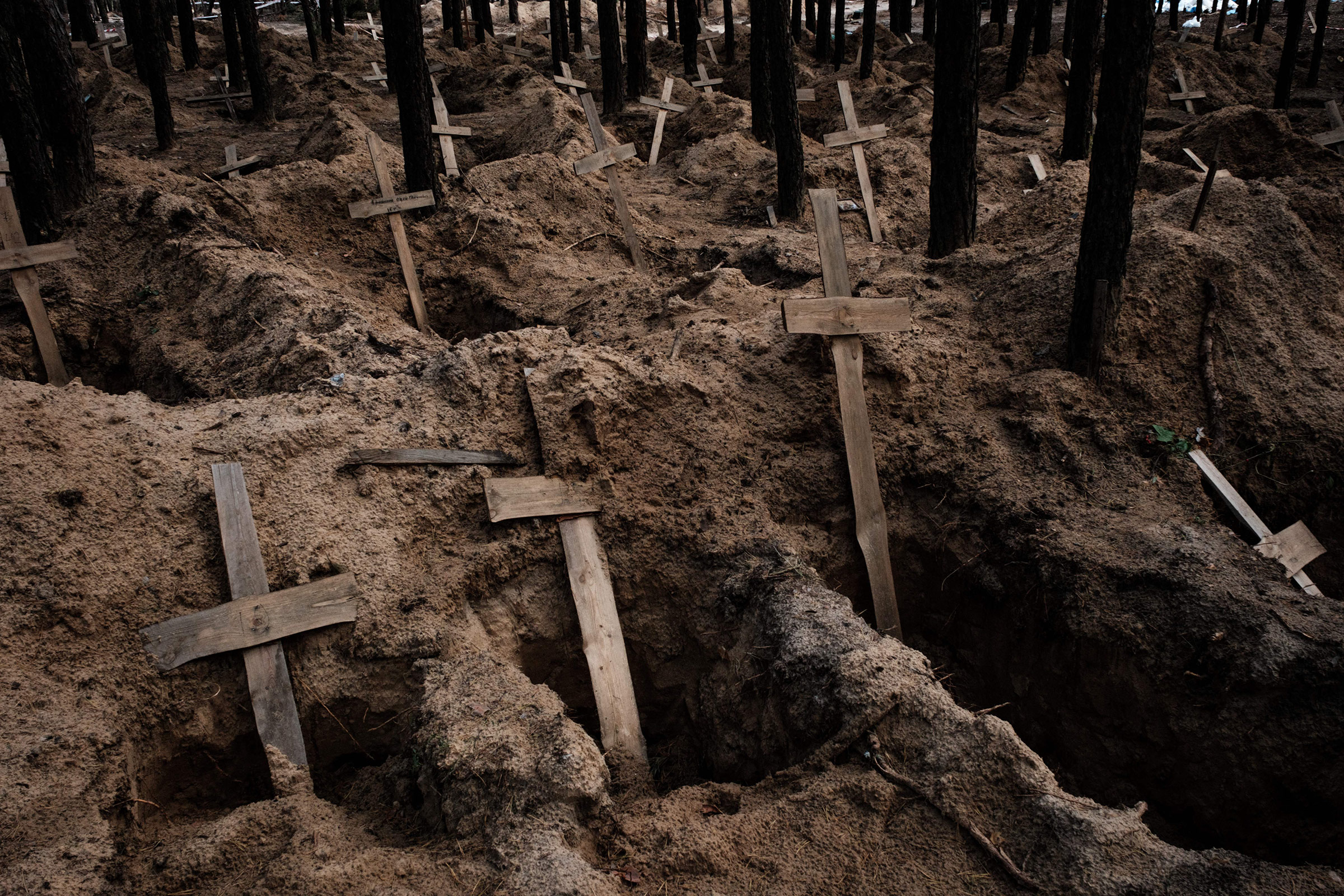 Graves unearthed in the town of Izyum, Sept. 2022, after territory was recaptured from Russian forces. (Yasuyoshi Chiba—AFP/Getty Images)
