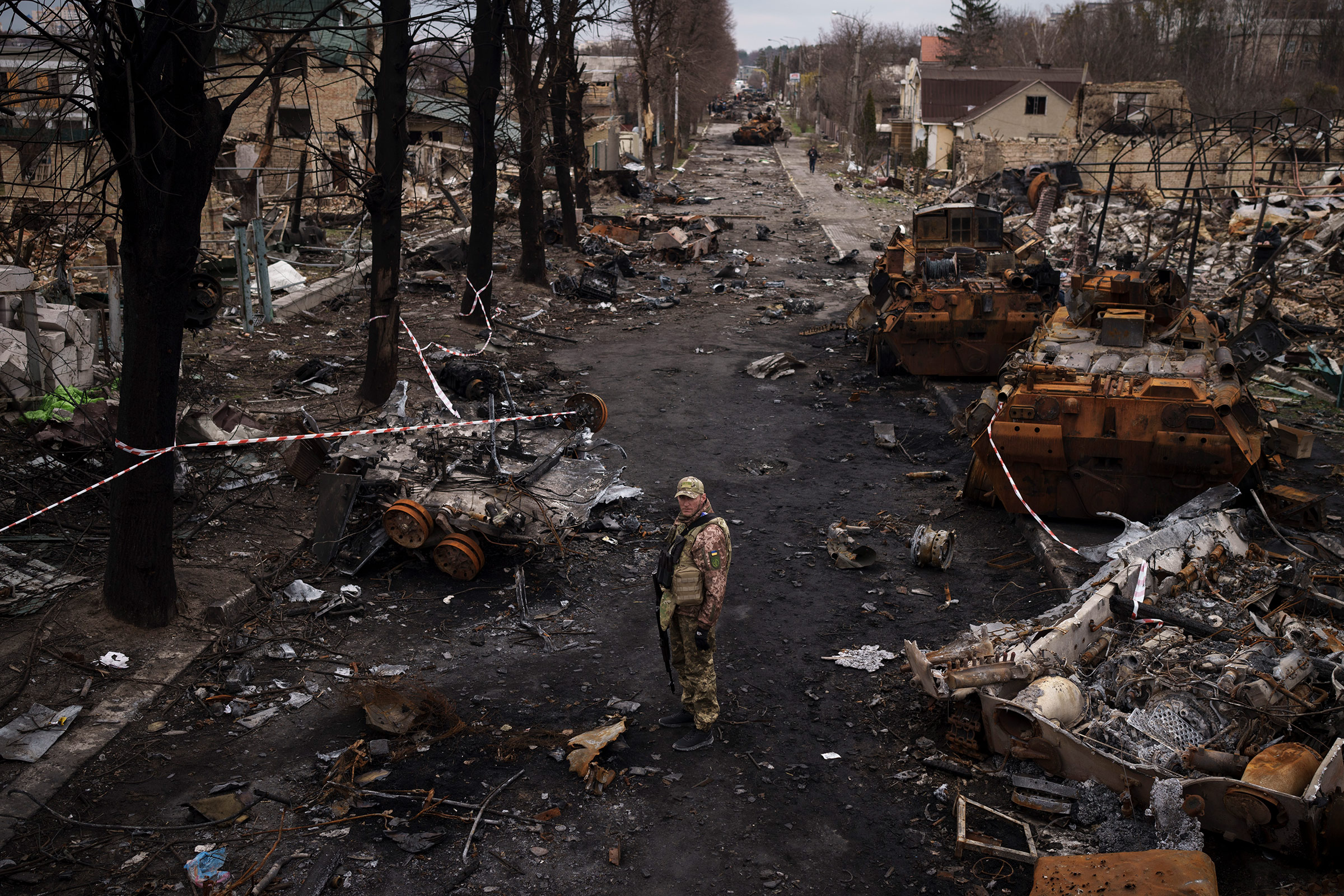 A Ukrainian serviceman stands amid destroyed Russian tanks in Bucha, April 6, 2022. (Felipe Dana—AP)