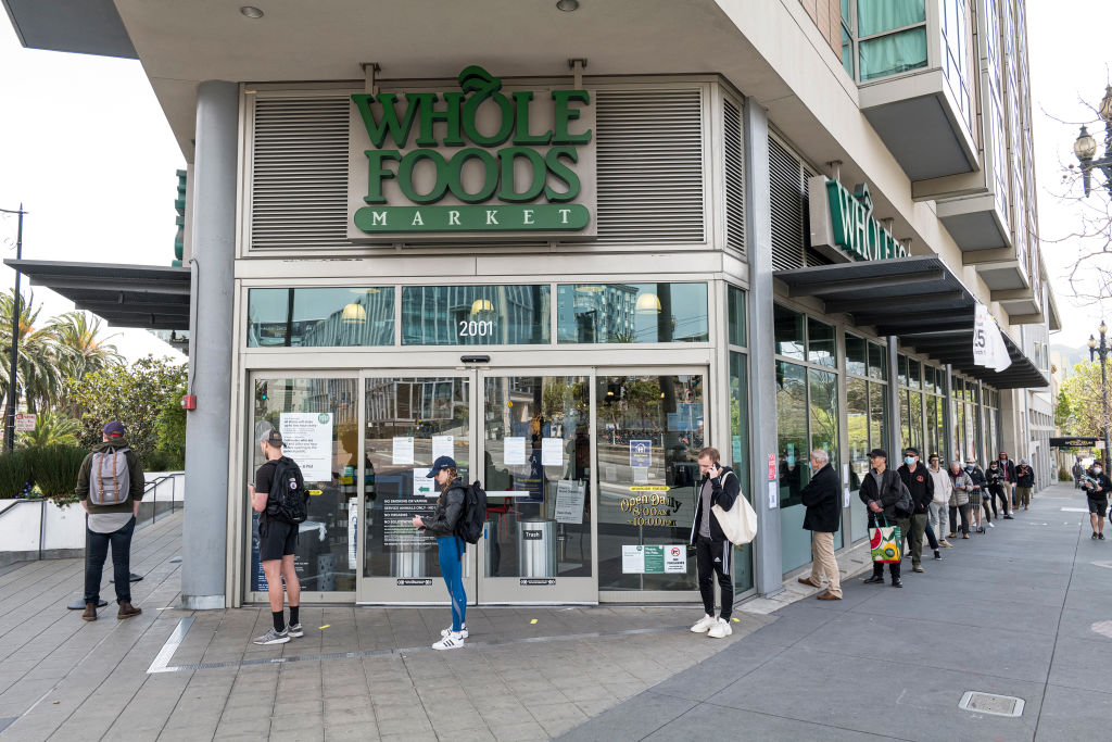 Customers wait in a line outside a Whole Foods store in San Francisco, California on Wednesday, April 8, 2020. (David Paul Morris—Bloomberg/Getty Images)