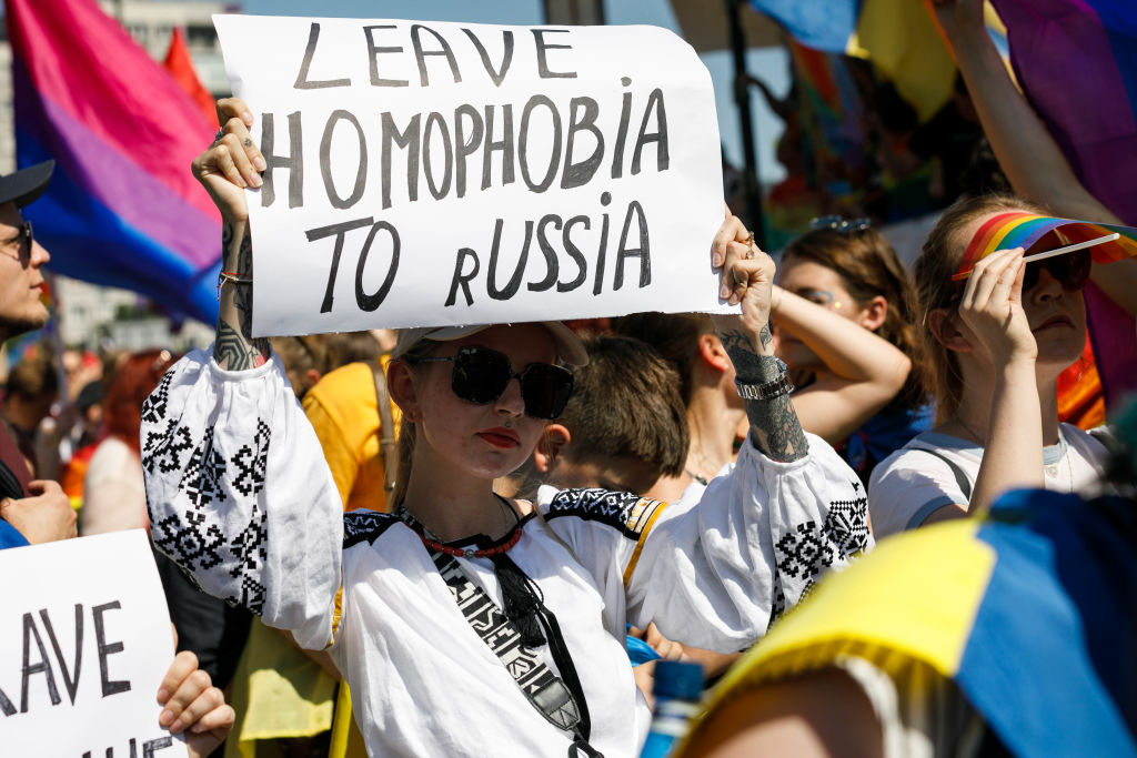 A woman holds a placard during the Warsaw Equality Parade. As well as LGBTQ and equality slogans, participants showed their support against the war and Russia's invasion of Ukraine. (Volha Shukaila—SOPA Images/LightRocket/ Getty Images)