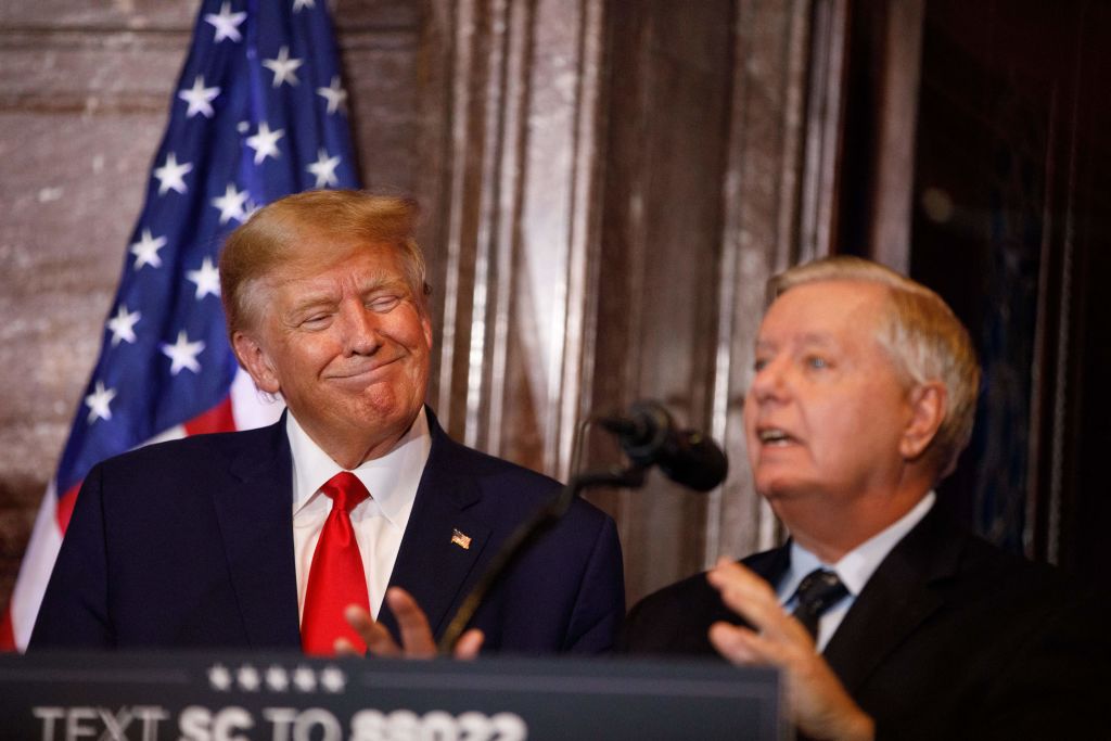 Former President Donald Trump smiles as US Senator Lindsey Graham, R-South Carolina, addresses the crowd during a campaign event in Columbia, South Carolina, on January 28, 2023 (Logan Cyrus —AFP via Getty Images)