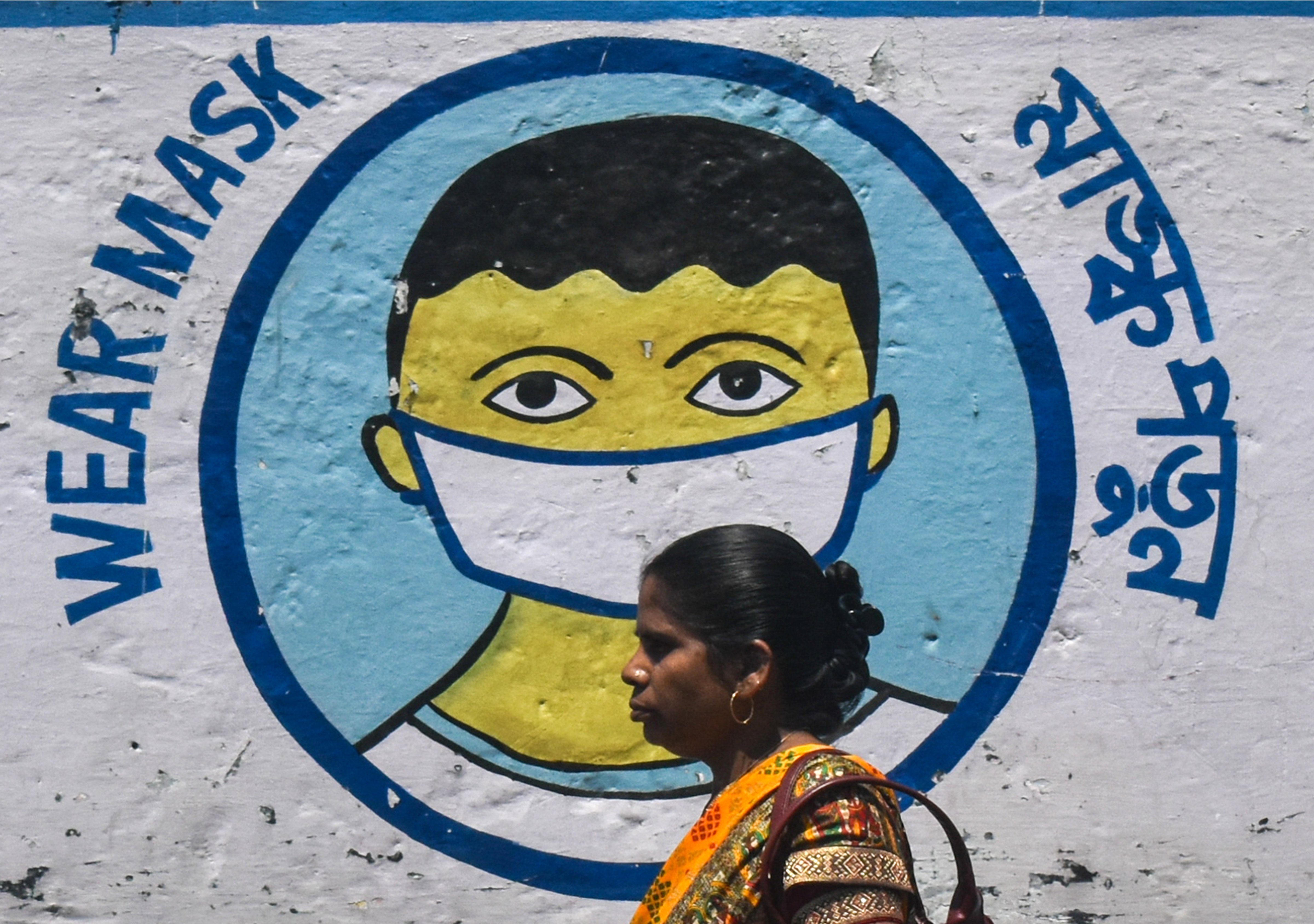A woman walks past a coronavirus-themed mural on a street amidst the spread of the coronavirus disease in Kolkata, India on Apr. 2 (Sudipta Das/NurPhoto—Getty Images)
