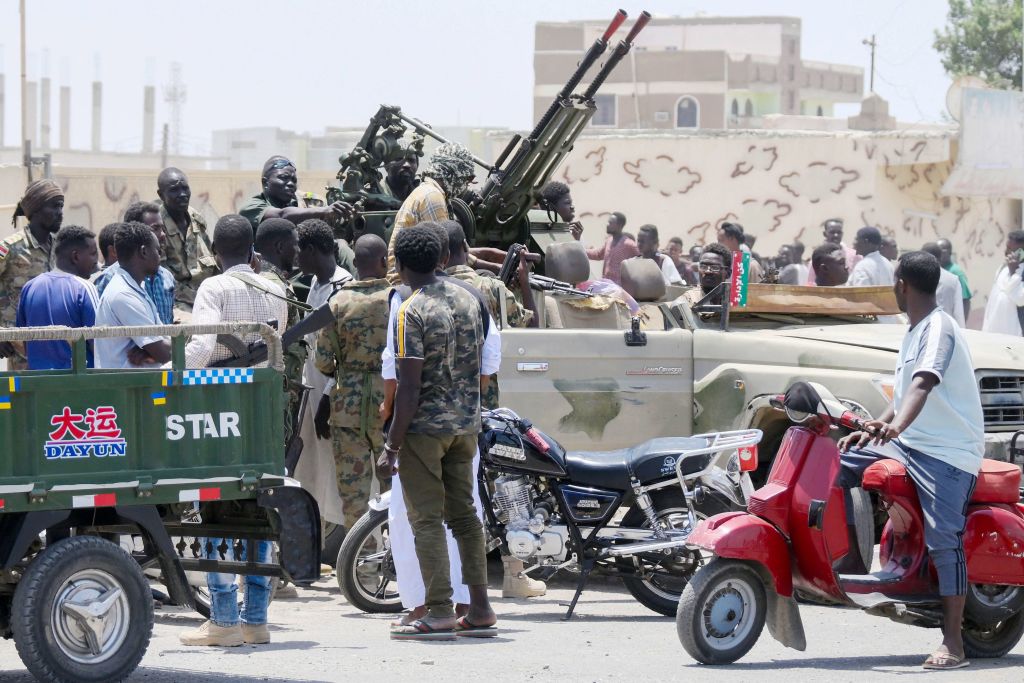 Sudanese greet army soldiers, loyal to army chief Abdel Fattah al-Burhan, in the Red Sea city of Port Sudan on April 16, 2023. (AFP via Getty Images)