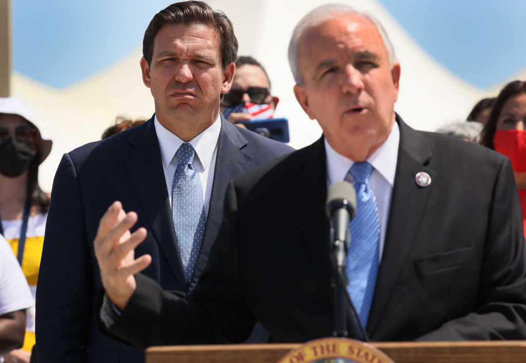 Florida Gov. Ron DeSantis listens as Rep. Carlos A. Gimenez, a fellow Florida Republican, speaks during a press conference on April 08, 2021 in Miami. Gimenez is poised to endorse Donald Trump this week. (Joe Raedle—Getty Images)