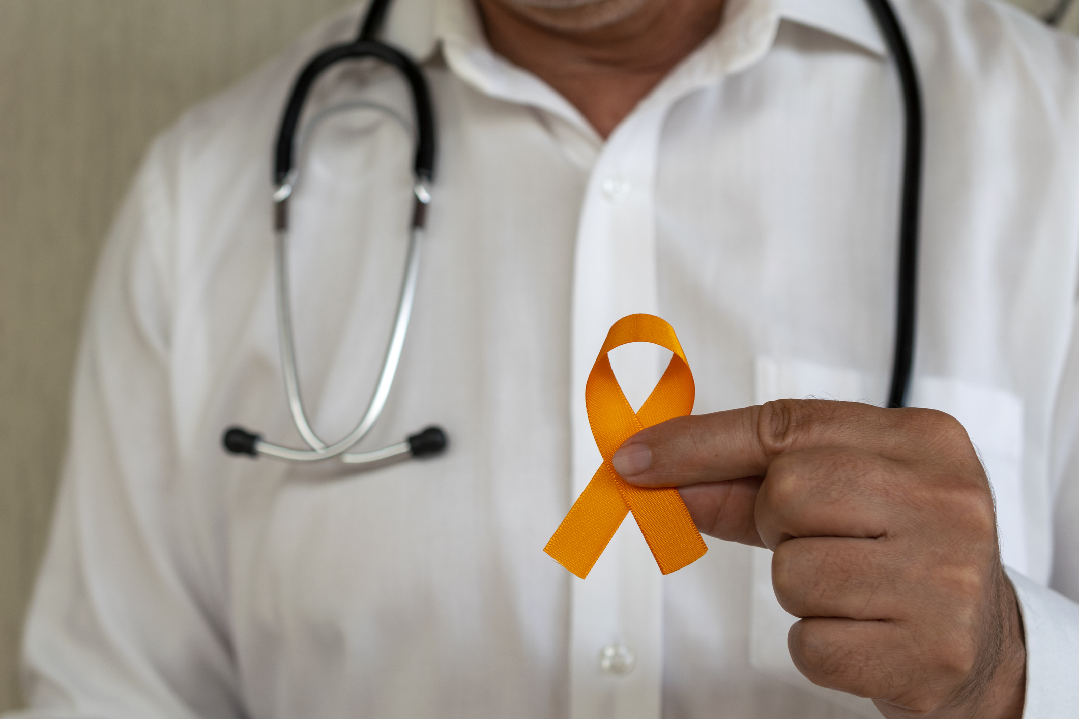doctor holding orange ribbon. campaign to prevent skin cancer, melanoma, December orange (Leonidas Santana—Getty Images)