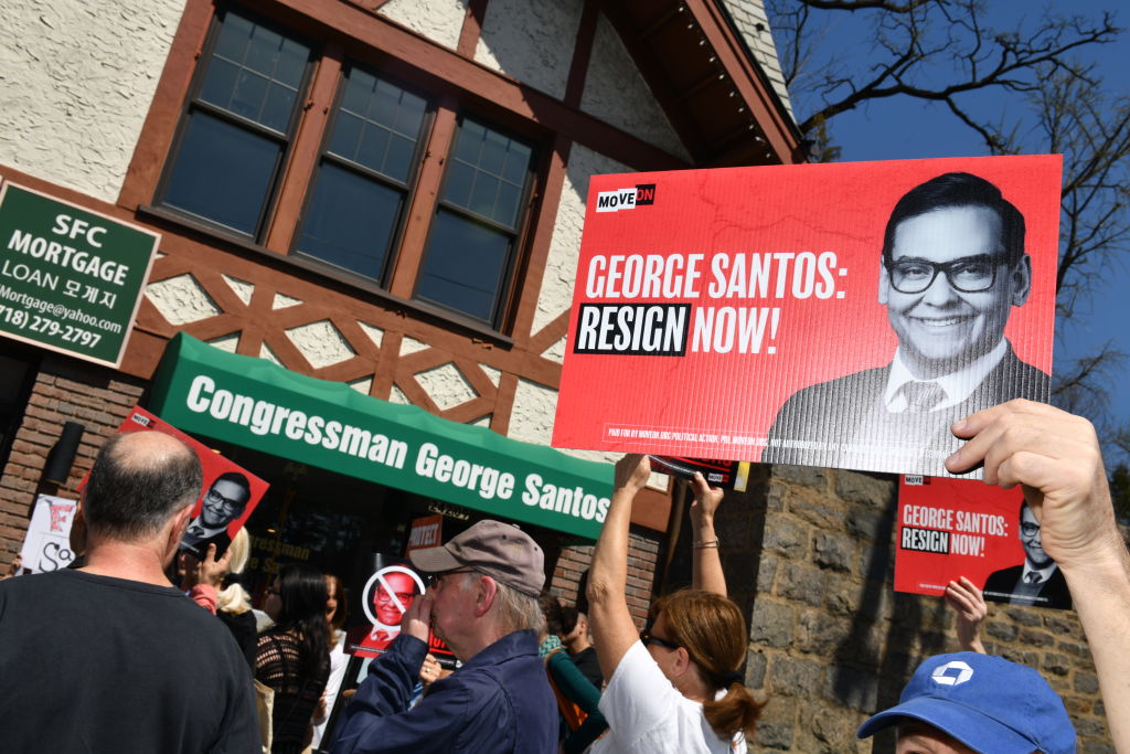 Activists organized by MoveOn protest Rep. George Santos on April 12, 2023 in Queens, New York (Craig Barritt—Getty Images for MoveOn)