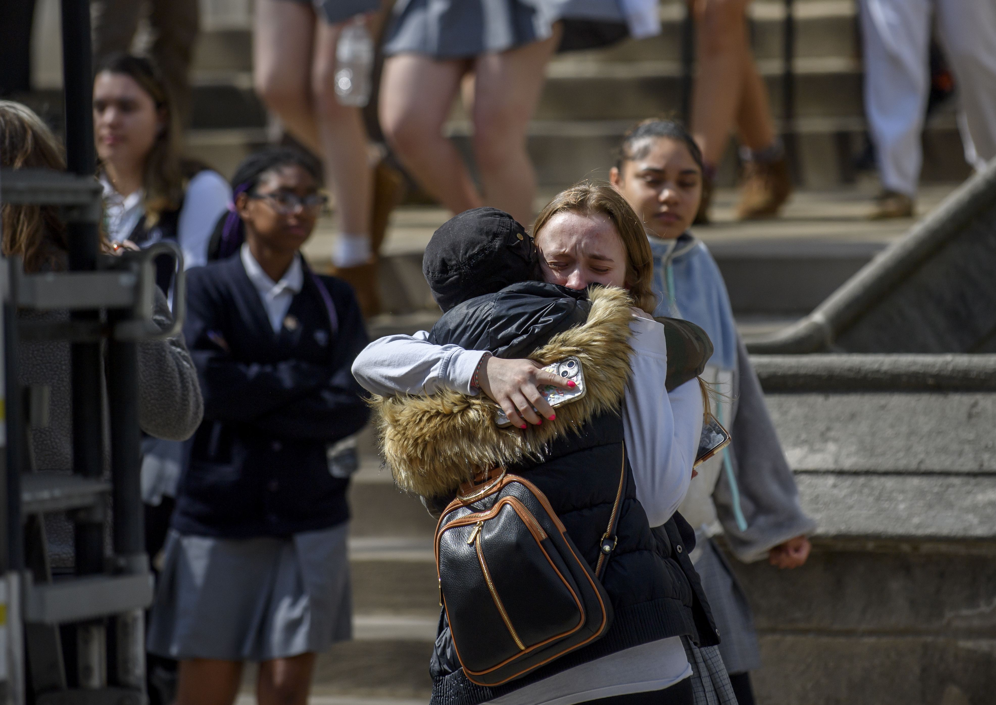 A student from Oakland Catholic High School receives comfort following the evacuation of her school after a hoax call about an active shooter on March 29 in Pittsburgh, Pennsylvania. (Jeff Swensen—Getty Images)