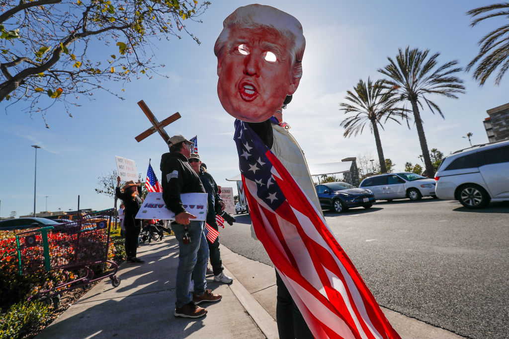 Donald Trump supporters gather for a demonstration at the corner in Laguna Hills, Calif. on April 4, 2023.  Earlier in the day, Trump was arraigned on 34 counts of falsifying business records in the first degree. (Robert Gauthier—Los Angeles Times/ Getty Images)