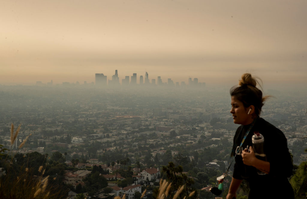 A jogger runs along  trail in Griffith Park as smoke from Southern California wildfires drifts over the L.A. Basin in a view from Griffith Observatory on Thursday, Sept. 17, 2020 in Los Angeles, CA. (Brian van der Brug —Los Angeles/Getty Images)