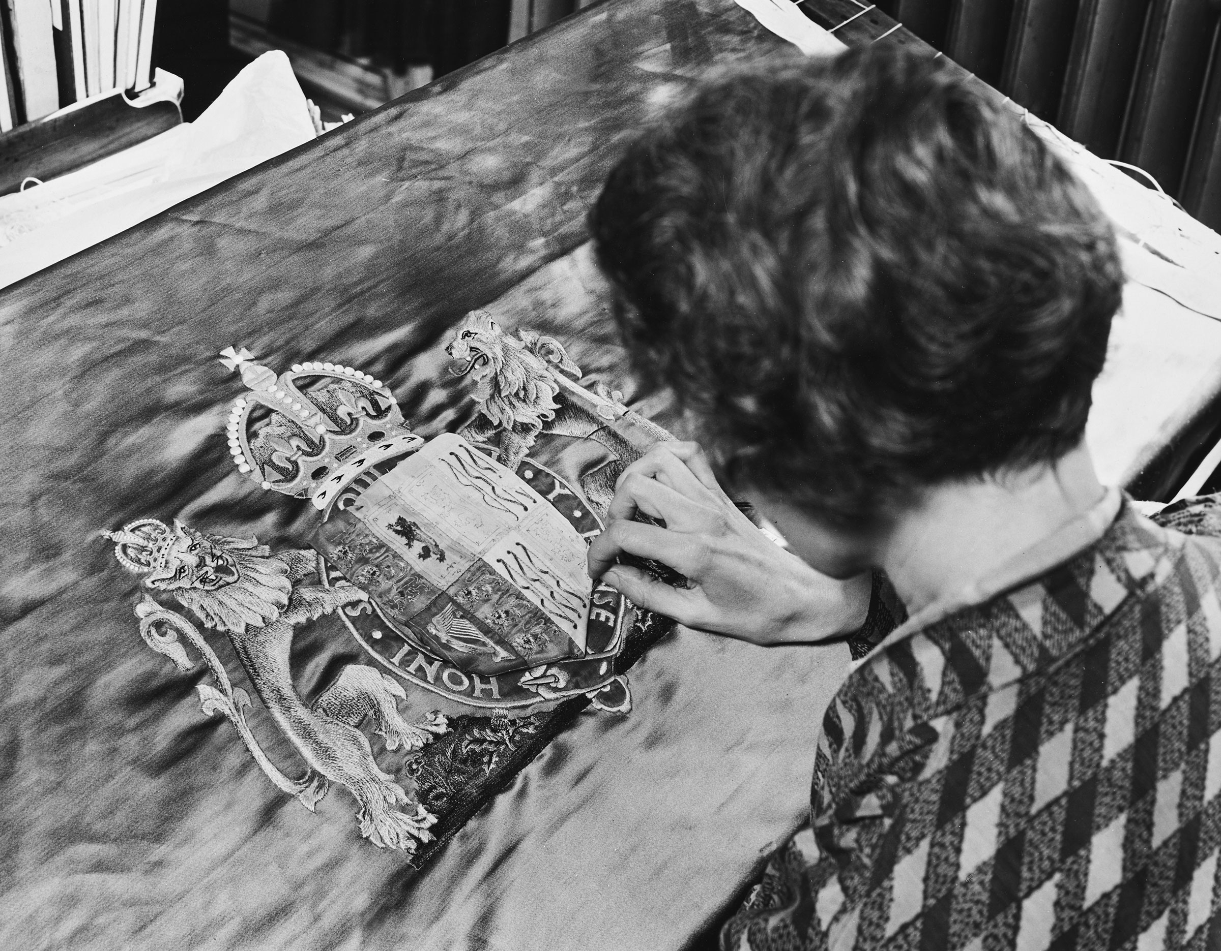 A woman sews Queen Elizabeth's crest for the Chair of Recognition, for the coronation ceremony of George VI and Queen Elizabeth, on March 18, 1937. (Fox Photos/Hulton Archive/Getty Images)