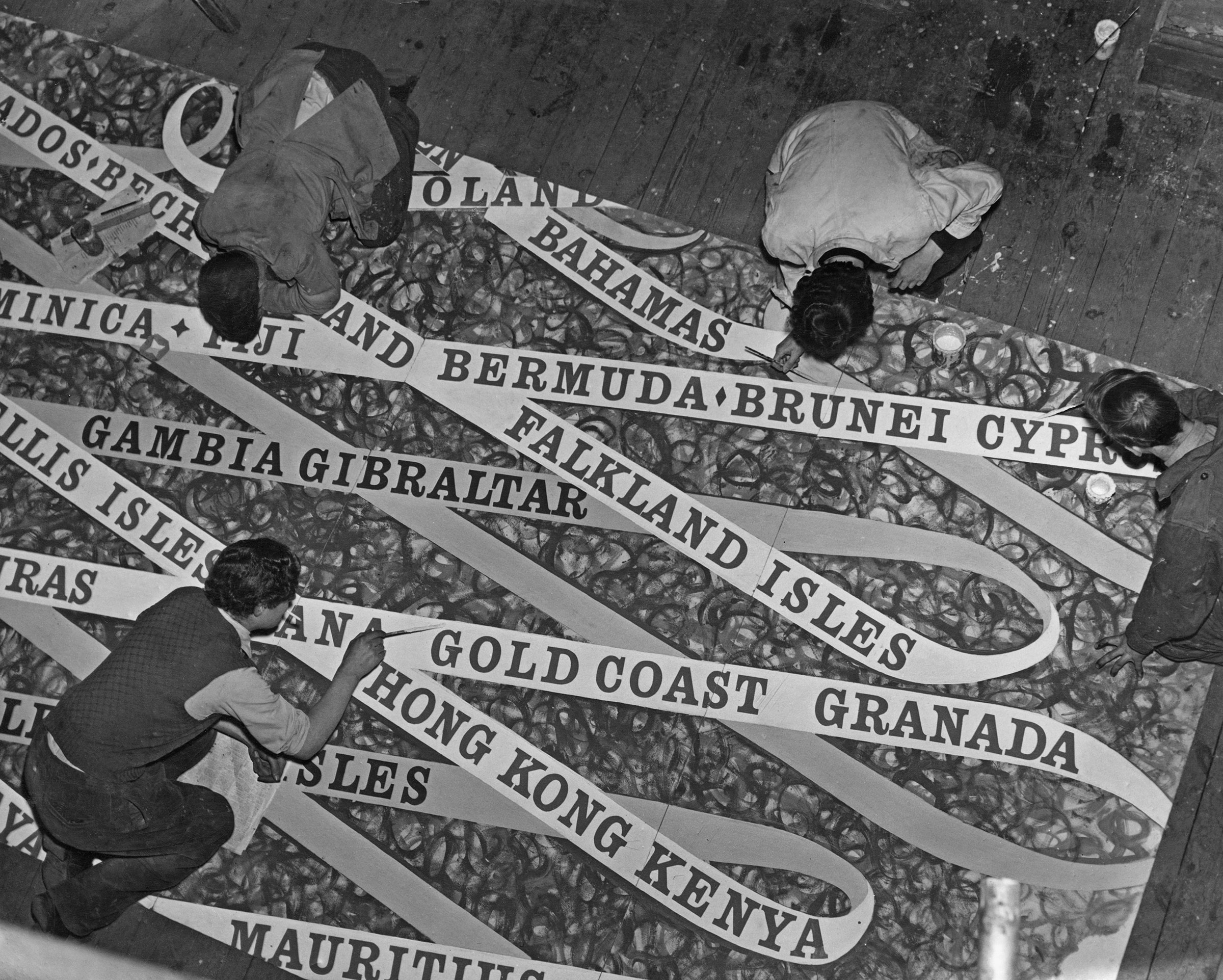 Students and artists from the Royal College of Art paint large scale emblems of the Commonwealth countries for the stands for the Coronation of Queen Elizabeth II, on April 28, 1953.