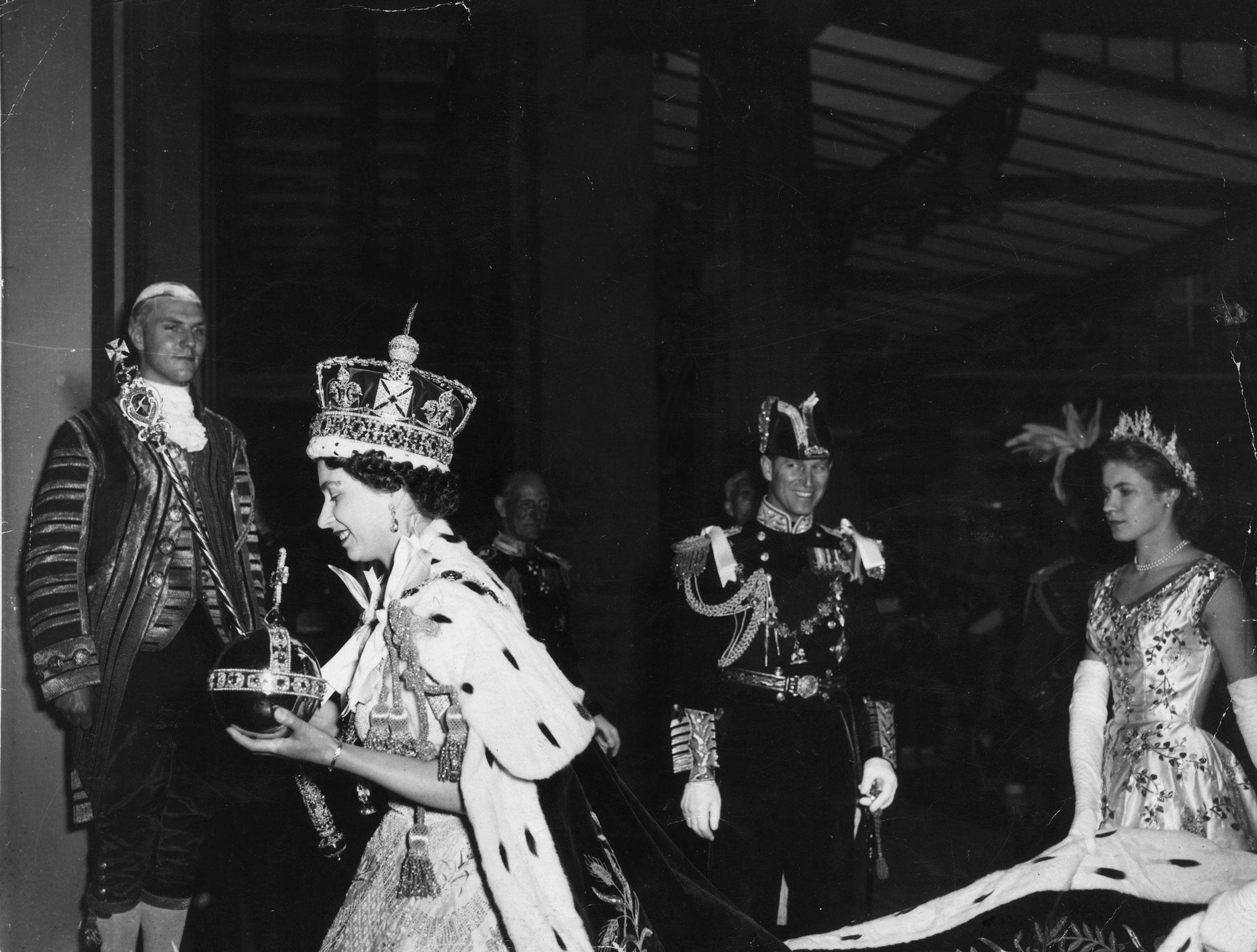 Queen Elizabeth II, wearing the Imperial State crown and carrying the Orb and Sceptre, returns to Buckingham Palace from Westminster Abbey, London, following her Coronation.
