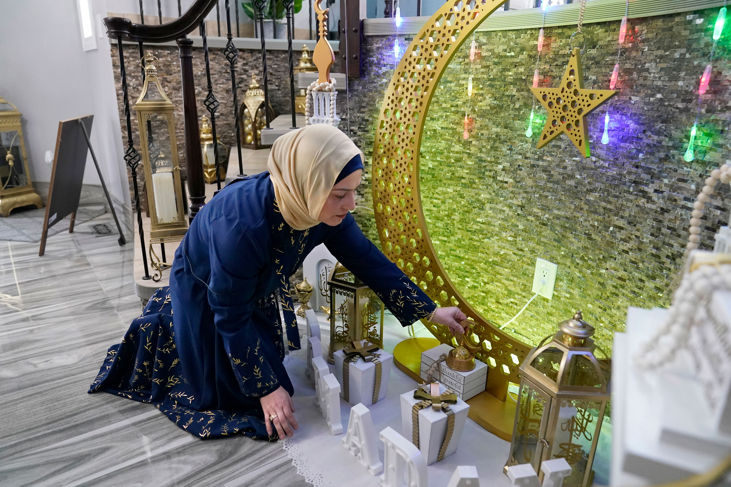 Suzanne Jaber of The Eid Shop looks at some of her company's Ramadan decorations she created, in Dearborn Heights, Mich., on March 27, 2023. (Carlos Osorio - AP)
