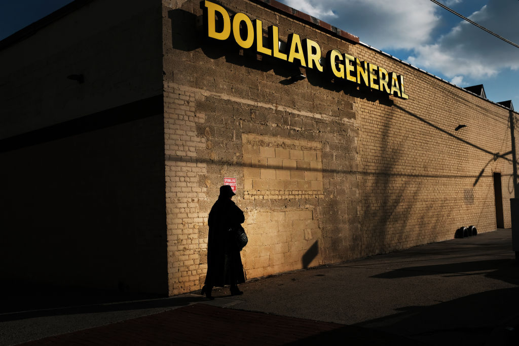 A woman walks by a Dollar General store in the Brooklyn borough of New York City. (Spencer Platt —Getty Images)