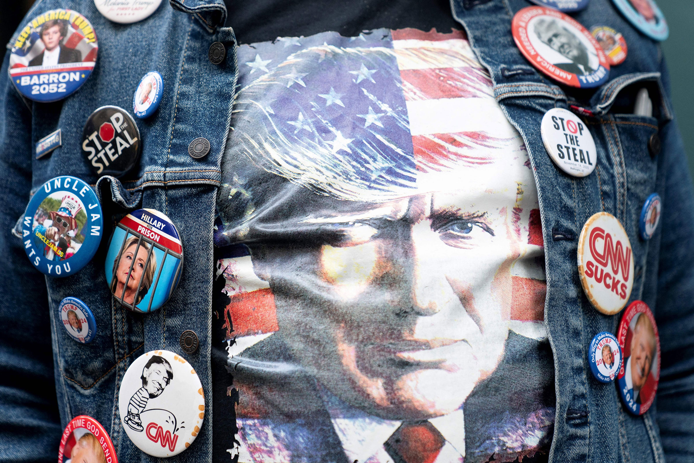 A supporter of former president Donald Trump wears buttons and a shirt with a picture of Trump near Trump Tower in New York on April 3, 2023. (Stefani Reynolds—AFP/Getty Images)