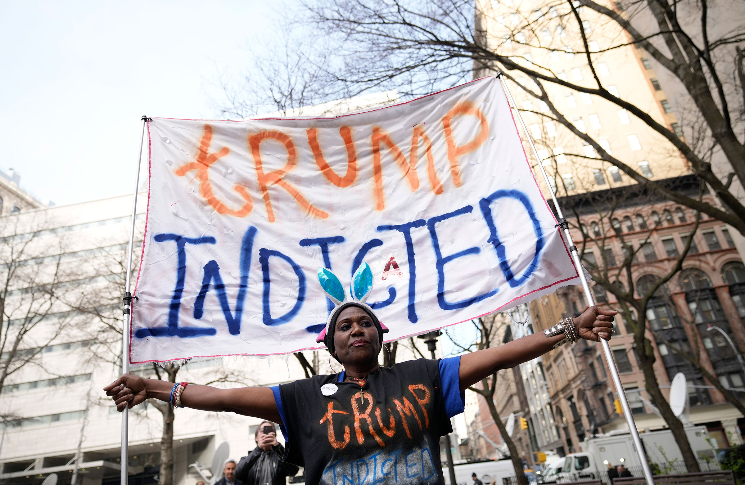 Nadine Seiler holds a sign while gathering outside the courthouse where former President Donald Trump will arrive for his arraignment in New York City on April 4, 2023.