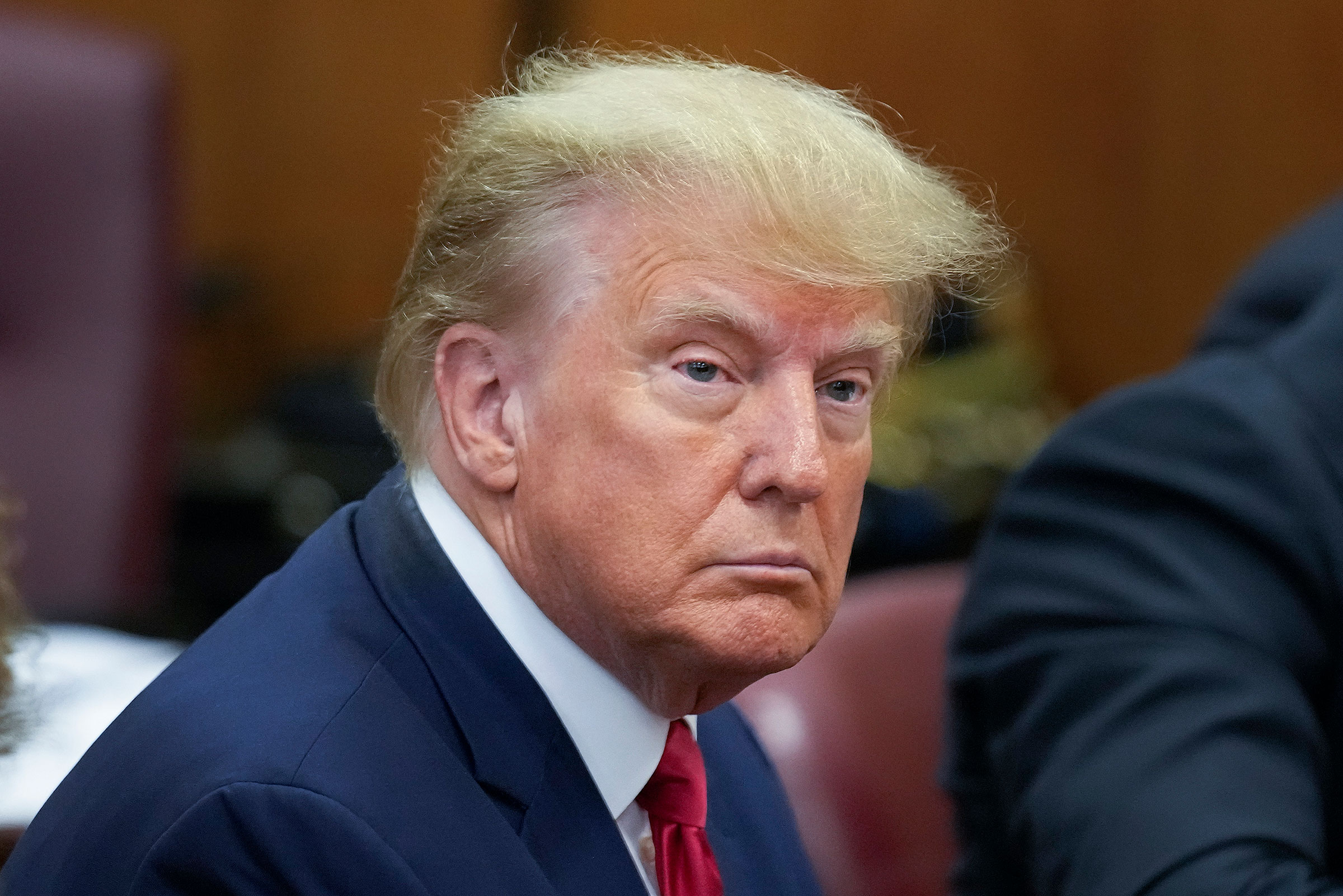 Former President Donald Trump sits at the defense table with his defense team in a Manhattan court, on April 4, 2023. (Seth Wenig—AP)
