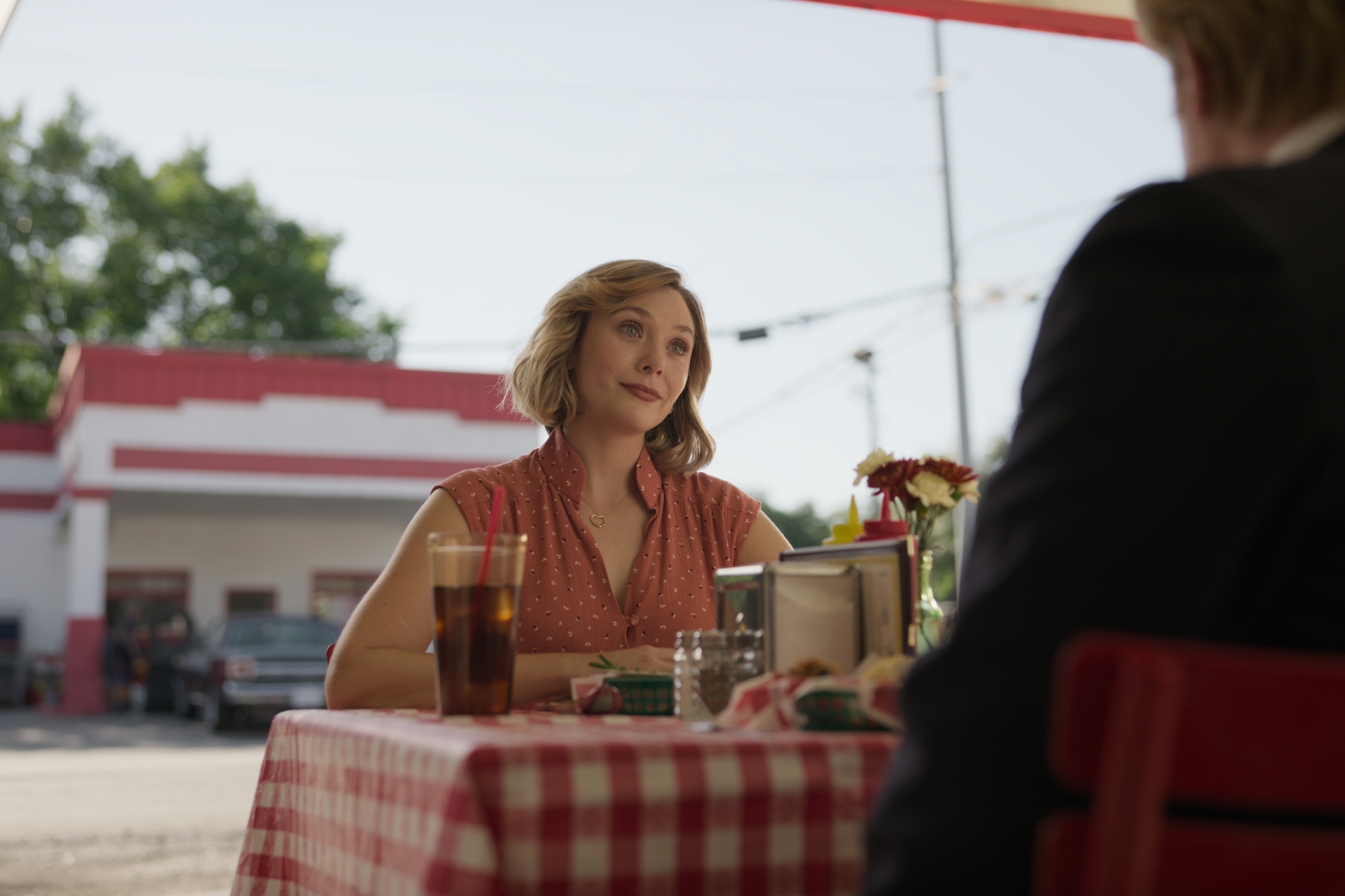 Elizabeth Olsen staring at a person across a table