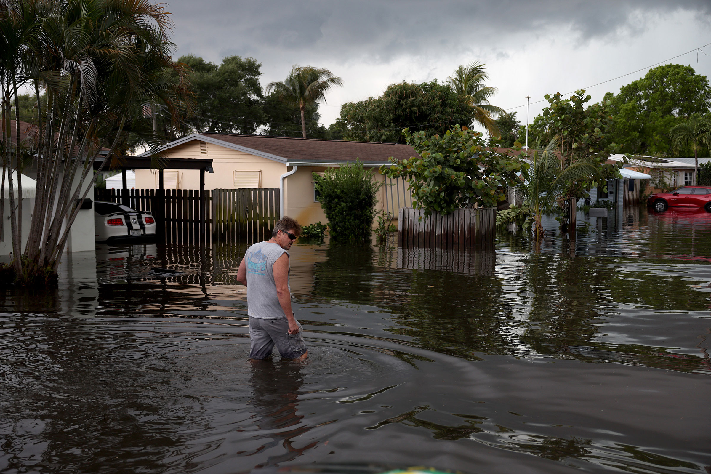 A person walks through a flooded street in Fort Lauderdale, Fla., on April 13, 2023.