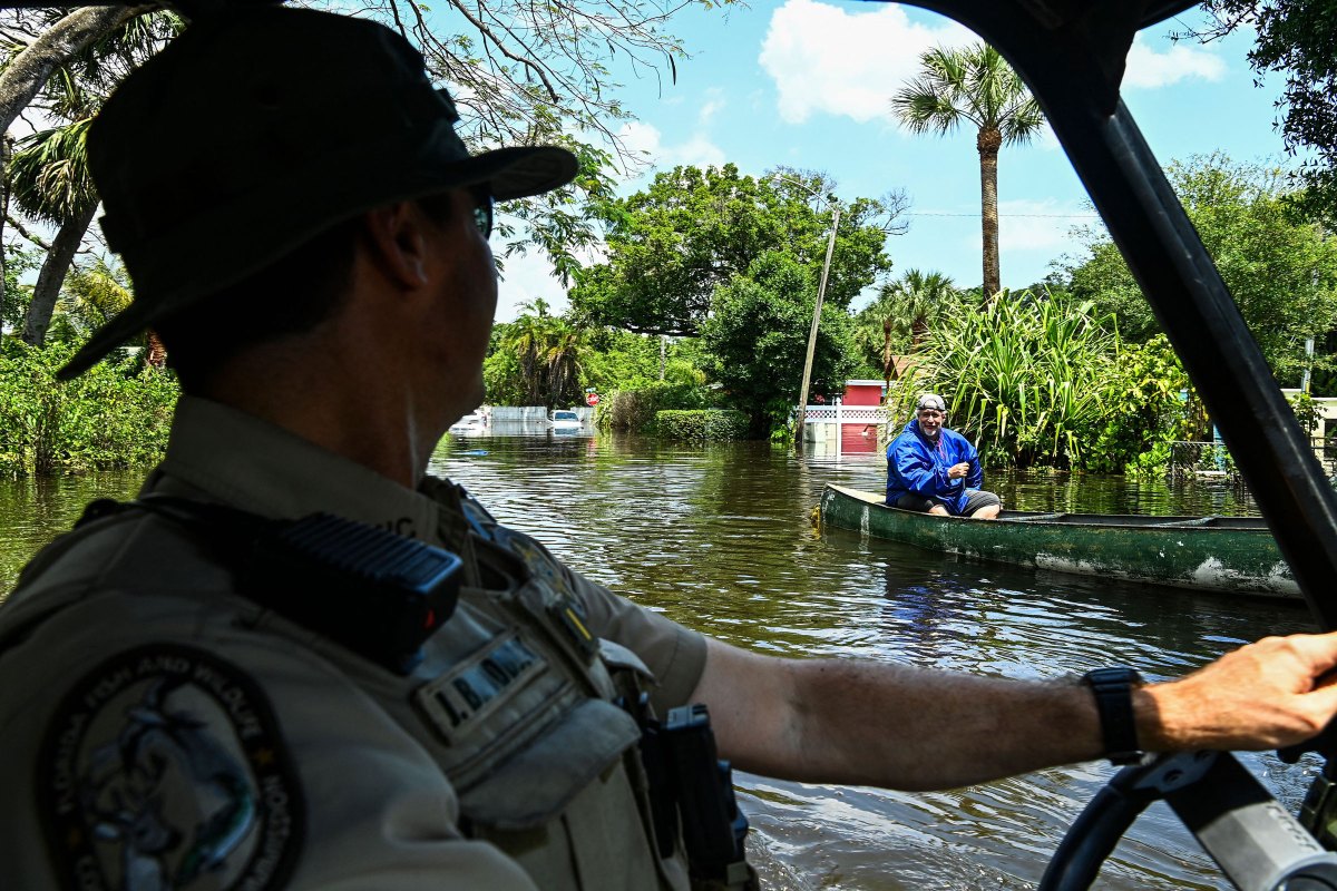 Lieutenant James Brodbeck of Florida Fish and Wildlife Conservation law enforcement patrols through the flooded neighborhood after heavy rain in Fort Lauderdale, Fla., on April 13, 2023.