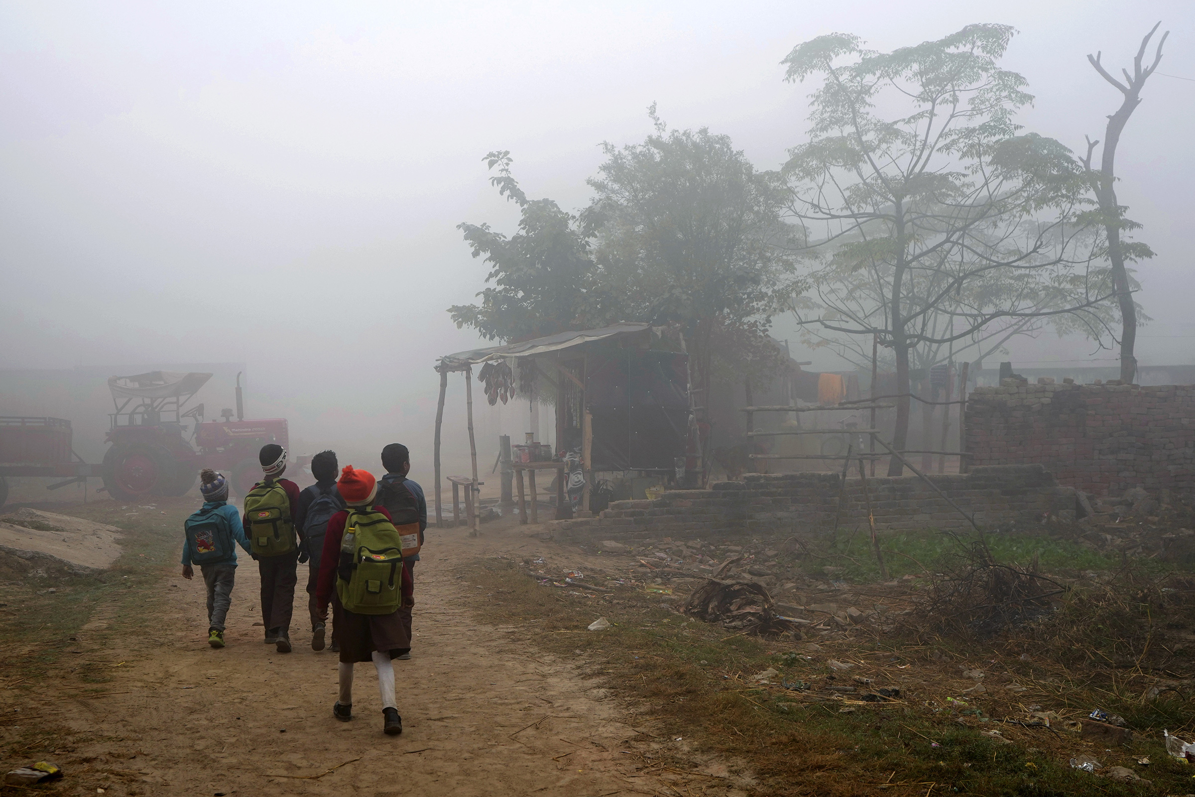 Children walk to school in Raebareli district of Uttar Pradesh, India, Dec. 20, 2022. (Rajesh Kumar Singh—AP)