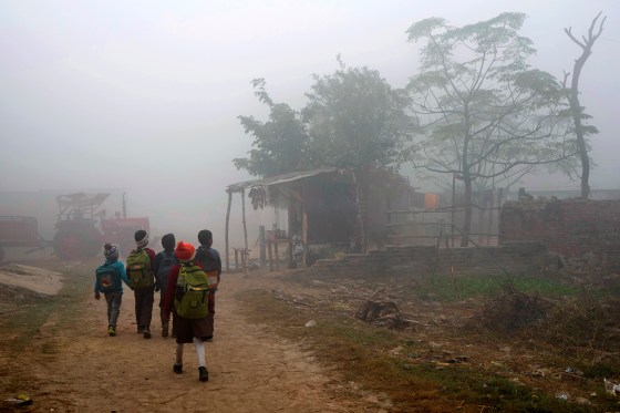 Children walk to school in Raebareli district of Uttar Pradesh, India, Dec. 20, 2022.
