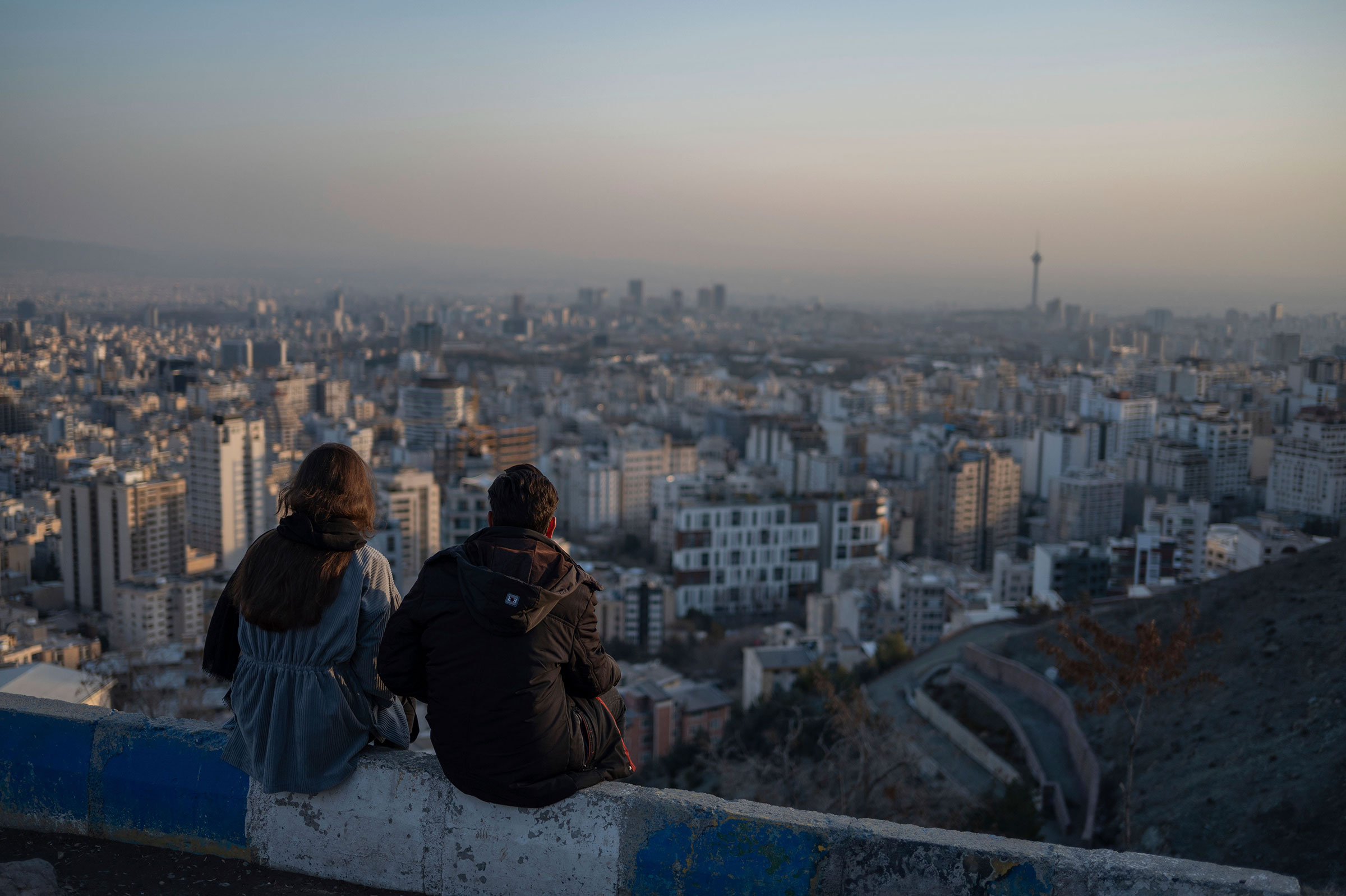 A couple sits at a popular scenic destination overlooking Tehran. (Arne Immanuel B'nsch—picture-alliance/dpa/AP)