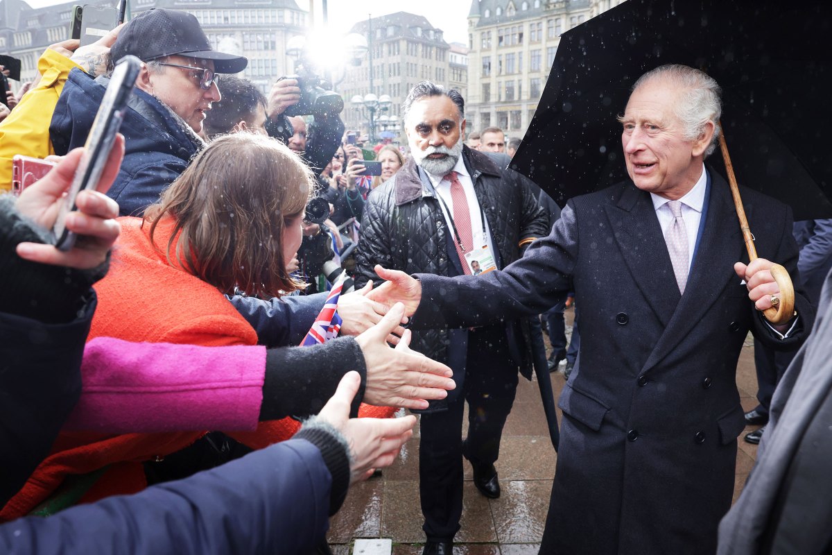 King Charles III greets members of the public during a walkabout outside Hamburg City Hall, the seat of the Hamburg government, on the final day of the King and Queen's State Visit to Germany on March 31, 2023.