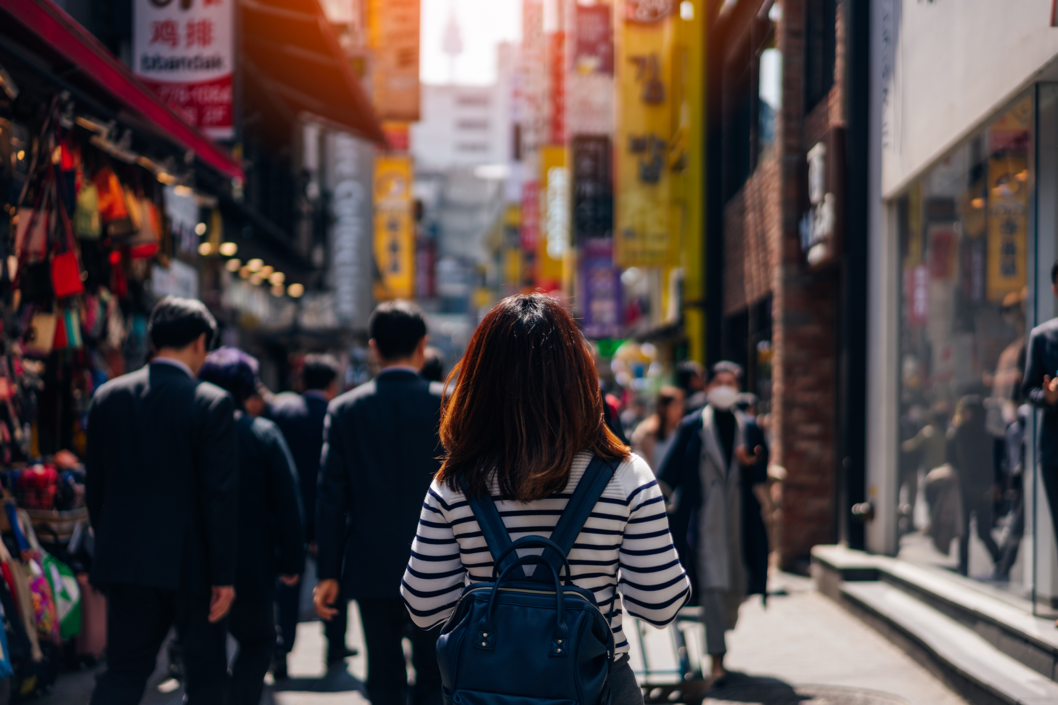 A young woman stands at Myeongdong street market in Seoul. (Mongkol Chuewong—Getty Images)