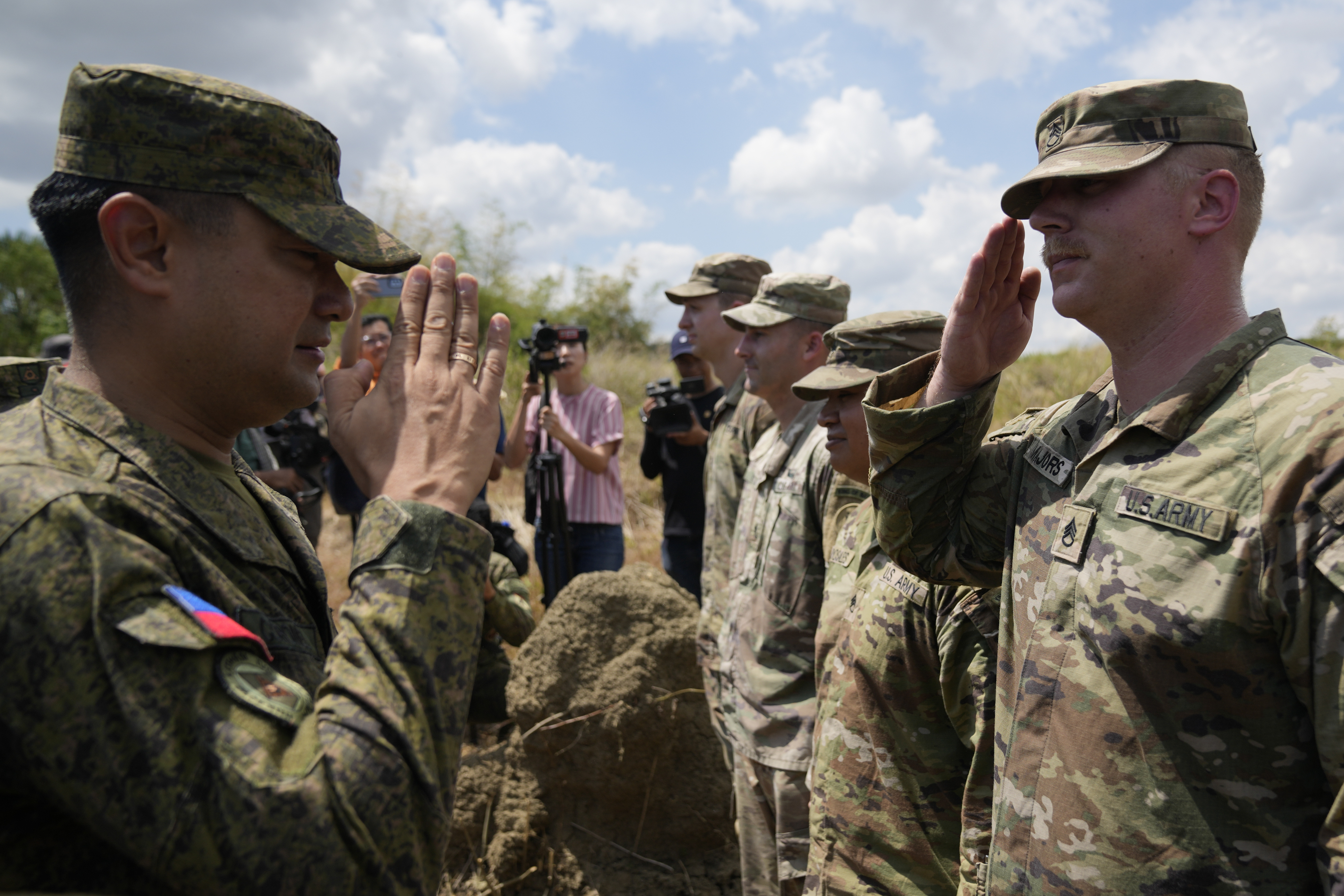 Philippine Army Artillery Regiment Commander Anthony Coronel, left, returns a salute from a U.S. soldier during a joint military drill in the northern Philippines on Friday, March 31, 2023. (Aaron Favila—AP)