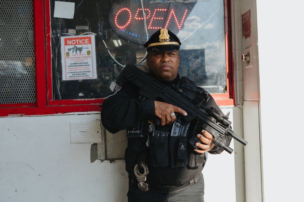 Andre Boyer an agent for S.I.T.E., an acronym for Strategic Intervention Tactical Enforcement, stands for a portrait while patrolling a Karco gas station.