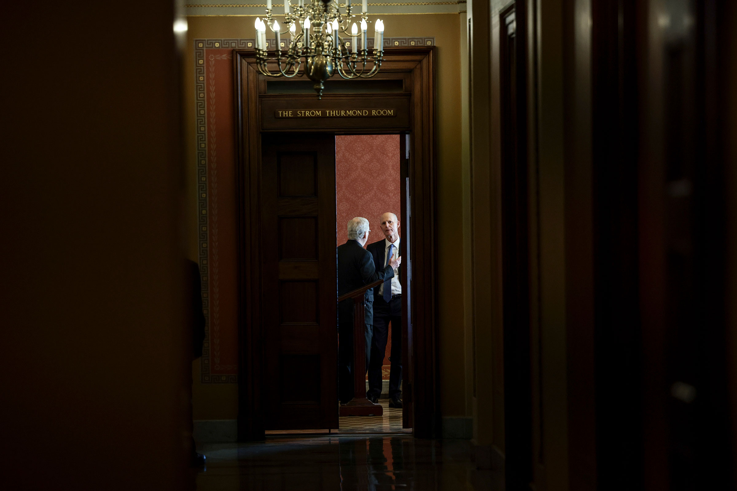 Senate Minority Leader Mitch McConnell speaks with Sen. Rick Scott before a meeting with Republican Senators on their party's plan for the vote on the debt limit at the Capitol on Oct. 07, 2021. (Anna Moneymaker—Getty Images)