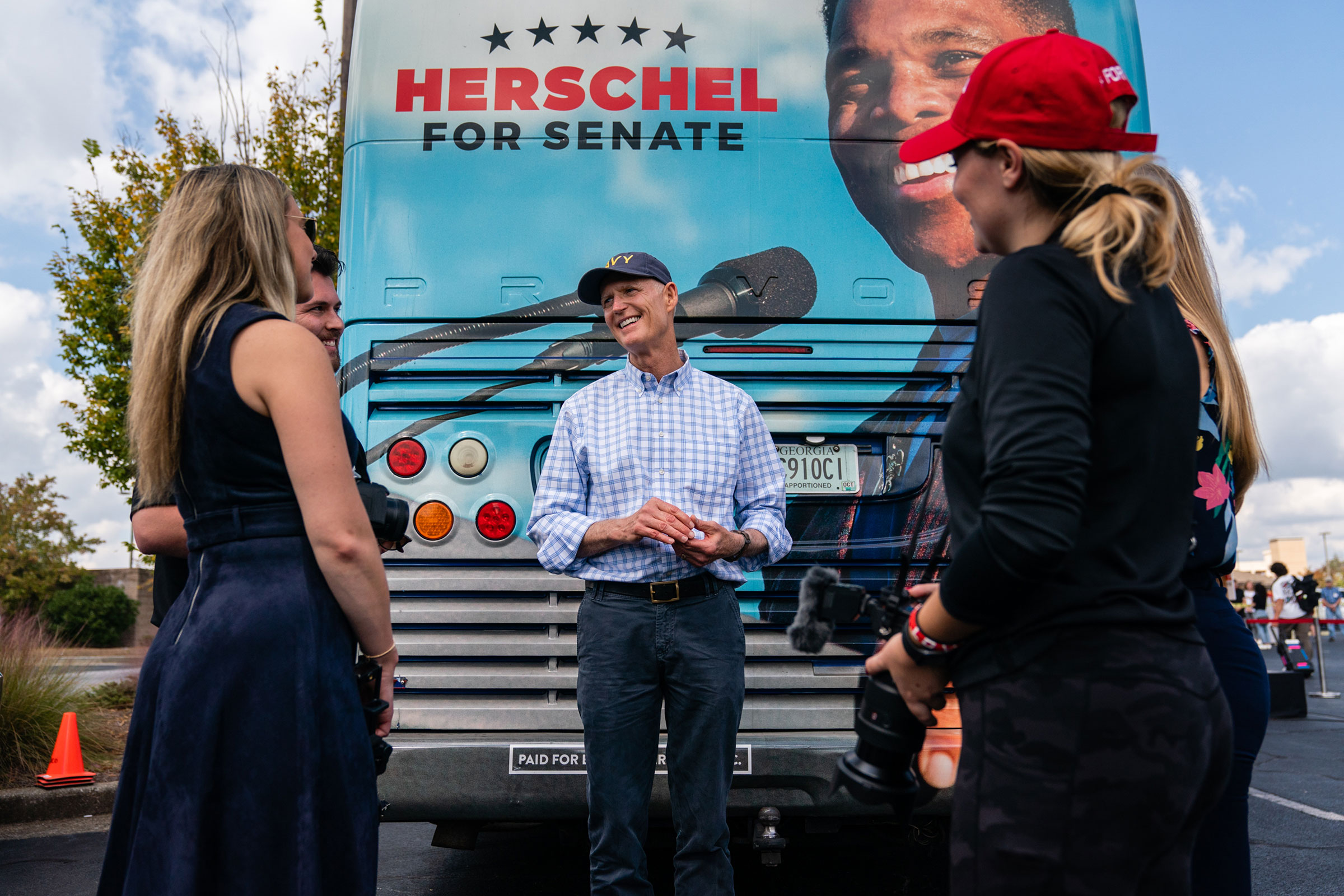 Scott speaks with campaign staff at a Herschel Walker campaign event in Carrollton, Ga., on Oct. 11, 2022.
