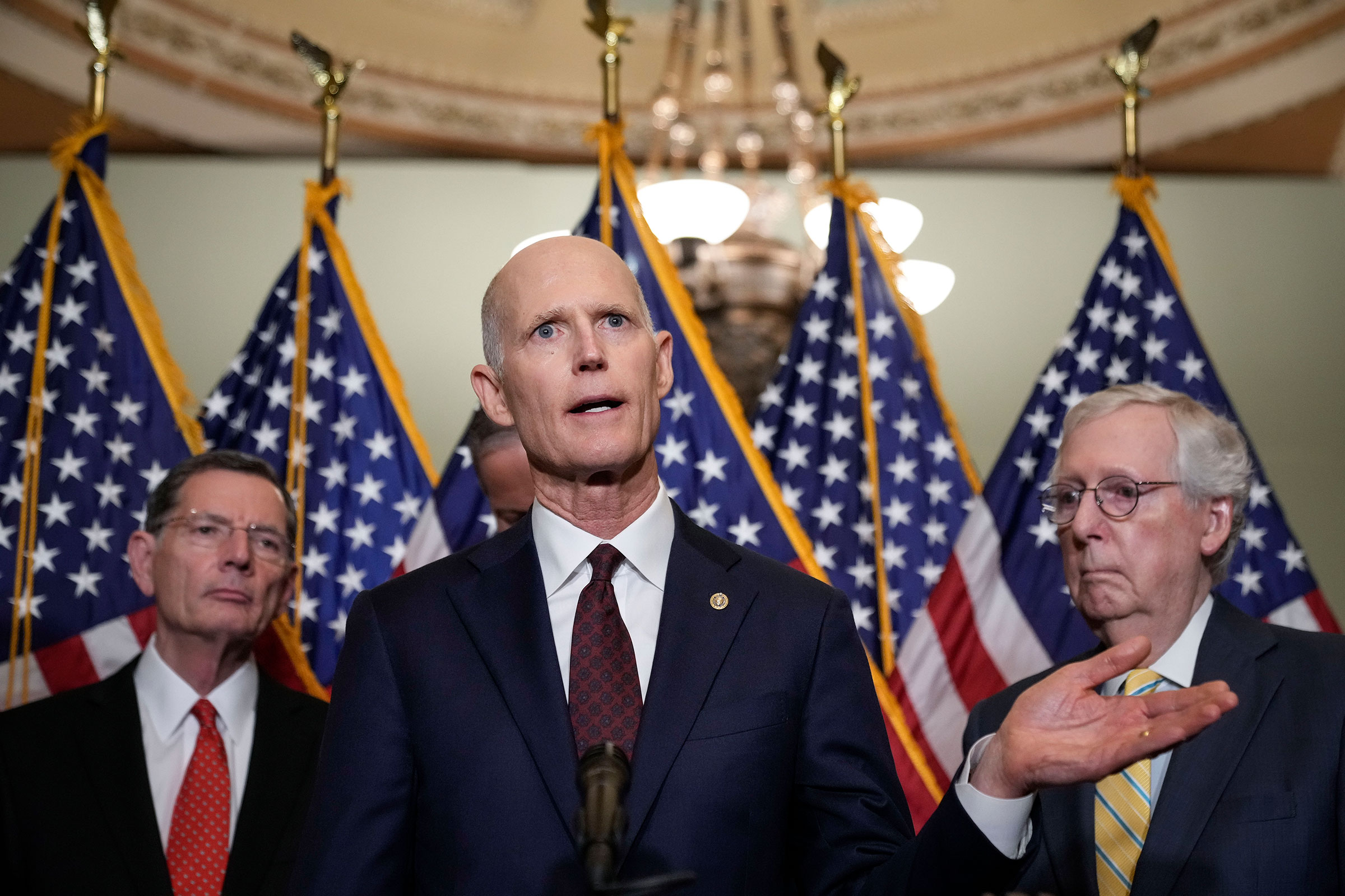 Flanked by Sen. John Barrasso and Senate Minority Leader Mitch McConnell, Sen. Rick Scott speaks during a news conference after a closed-door lunch with Senate Republicans at the Capitol on May 17, 2022. (Drew Angerer—Getty Images)