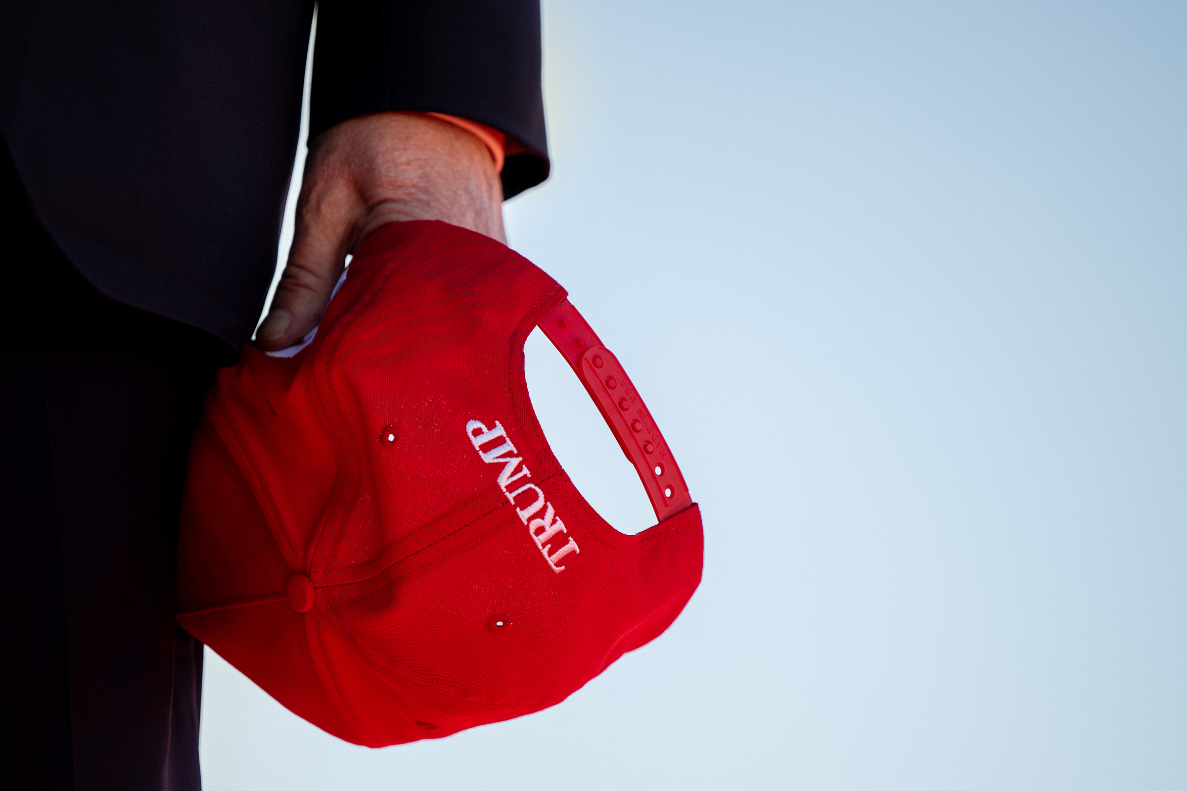 Former U.S. President Donald Trump holds his cap during arrival at a rally at the Waco Regional Airport on March 25 in Waco, Texas. (Brandon Bell—Getty Images)