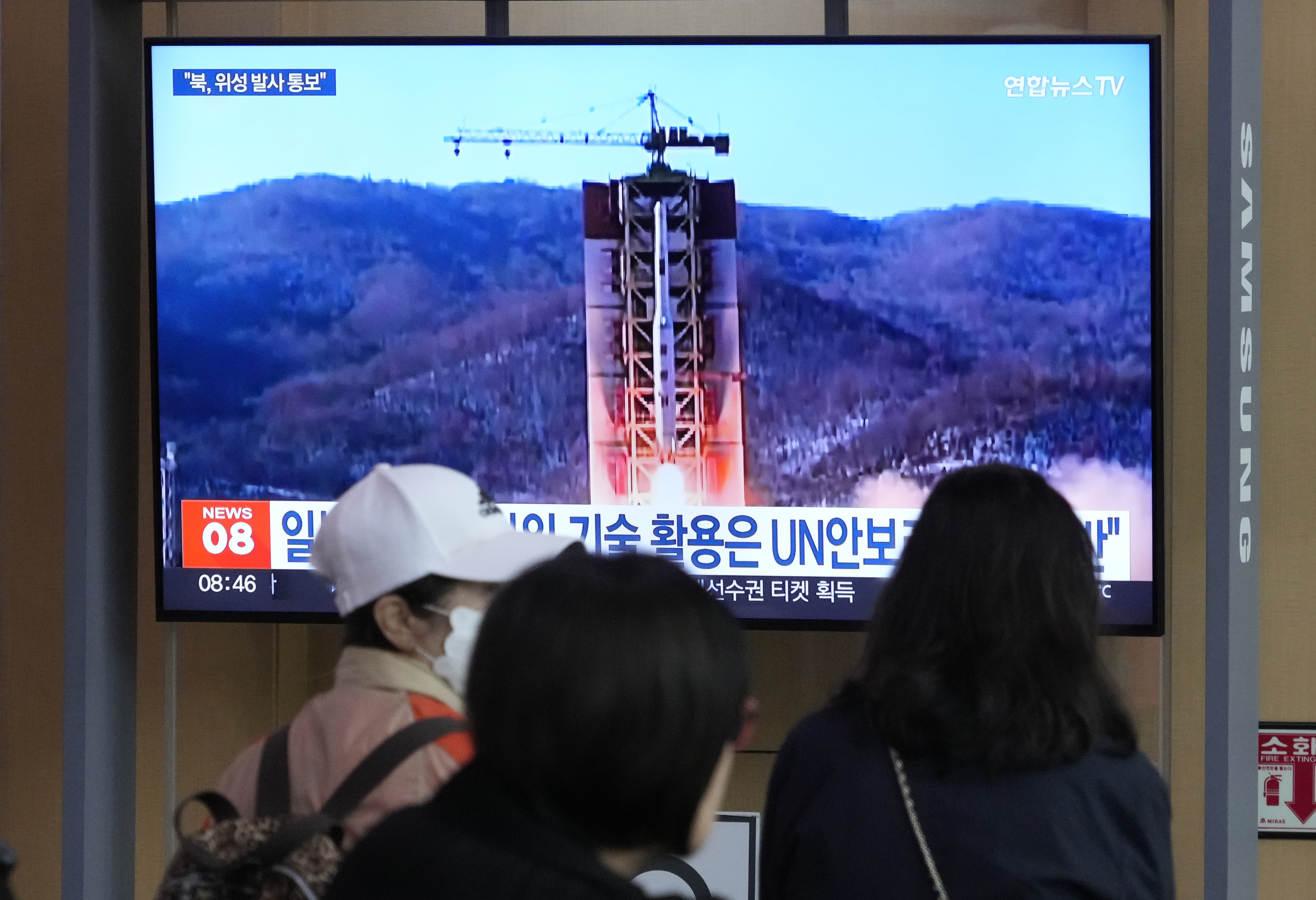 A TV screen shows a file image of North Korea's rocket launch during a news program at a railway station in Seoul. (Ahn Young-joon—AP Photo)