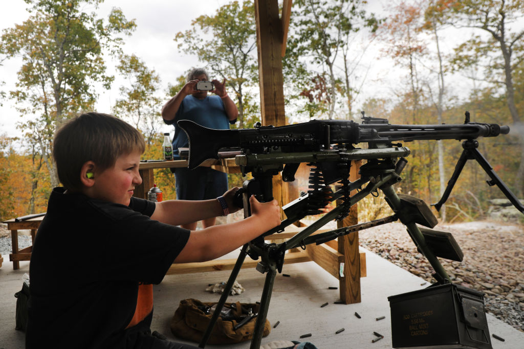 A young boy shoots an AR-15 and other weapons during the “Rod of Iron Freedom Festival” on October 12, 2019 in Greeley, Pennsylvania. The two-day event billed itself as a “Second Amendment rally and celebration of freedom, faith and family.” (Spencer Platt—Getty Images)