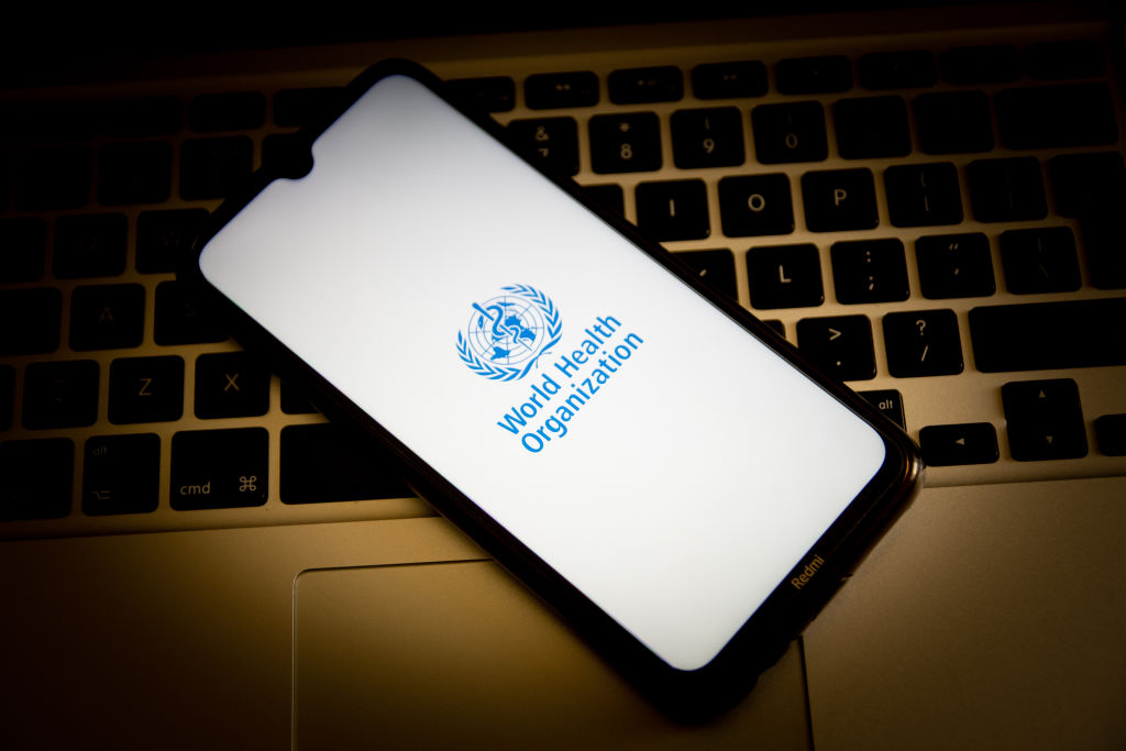 In this photo illustration, a World Health Organization logo