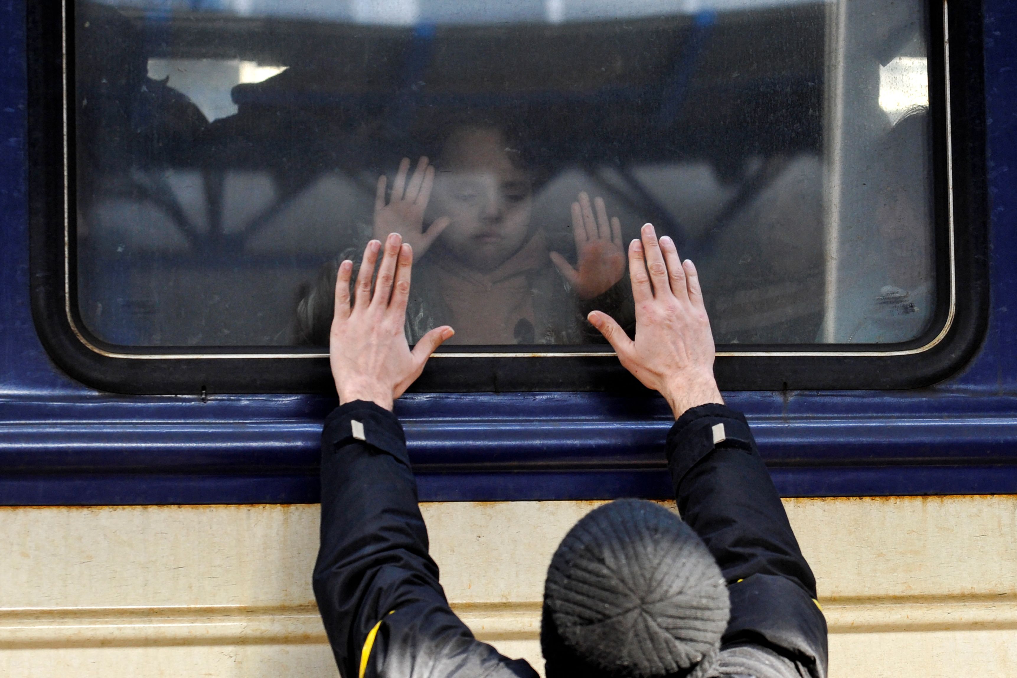 A man gestures in front of an evacuation train at Kyiv central train station on March 4, 2022. (Sergei Chuzavkov—AFP/Getty Images)