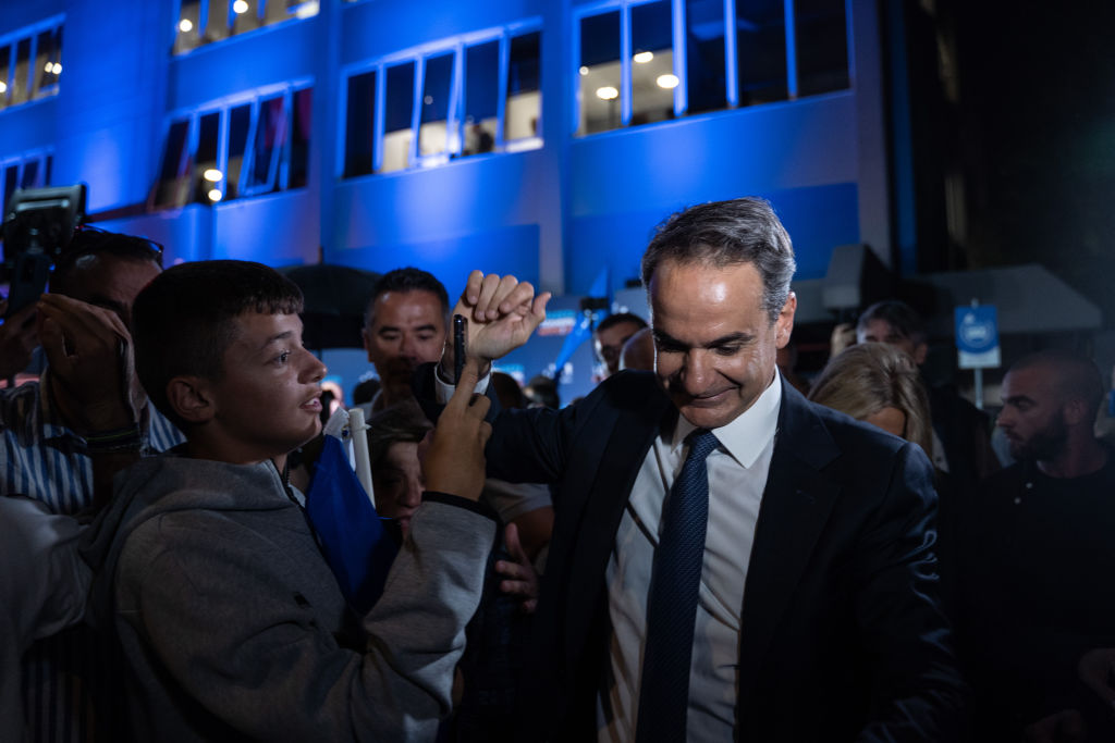Kyriakos Mitsotakis, Greece's prime minister and leader of New Democracy party, right, departs the party's headquarters following Greece's general election, in Athens, Greece, on Sunday, May 21, 2023. (Nick Paleologos—Bloomberg via Getty Images)