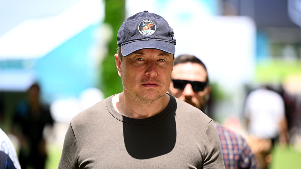 Elon Musk walks in the Paddock prior to final practice ahead of the F1 Grand Prix of Miami at Miami International Autodrome on May 06, 2023 in Miami, Florida. (Clive Mason—Formula 1 /Getty Images)