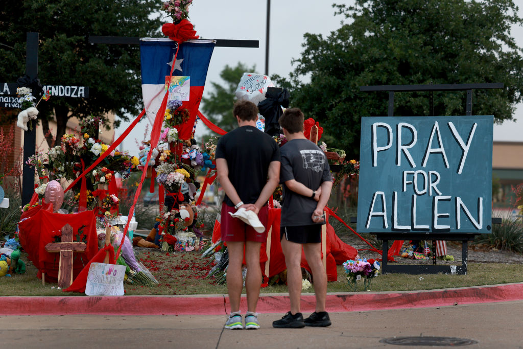 People visit the memorial near the scene of a mass shooting at the Allen Premium Outlets mall on May 9, 2023 in Allen, Texas. (Joe Raedle—Getty Images)
