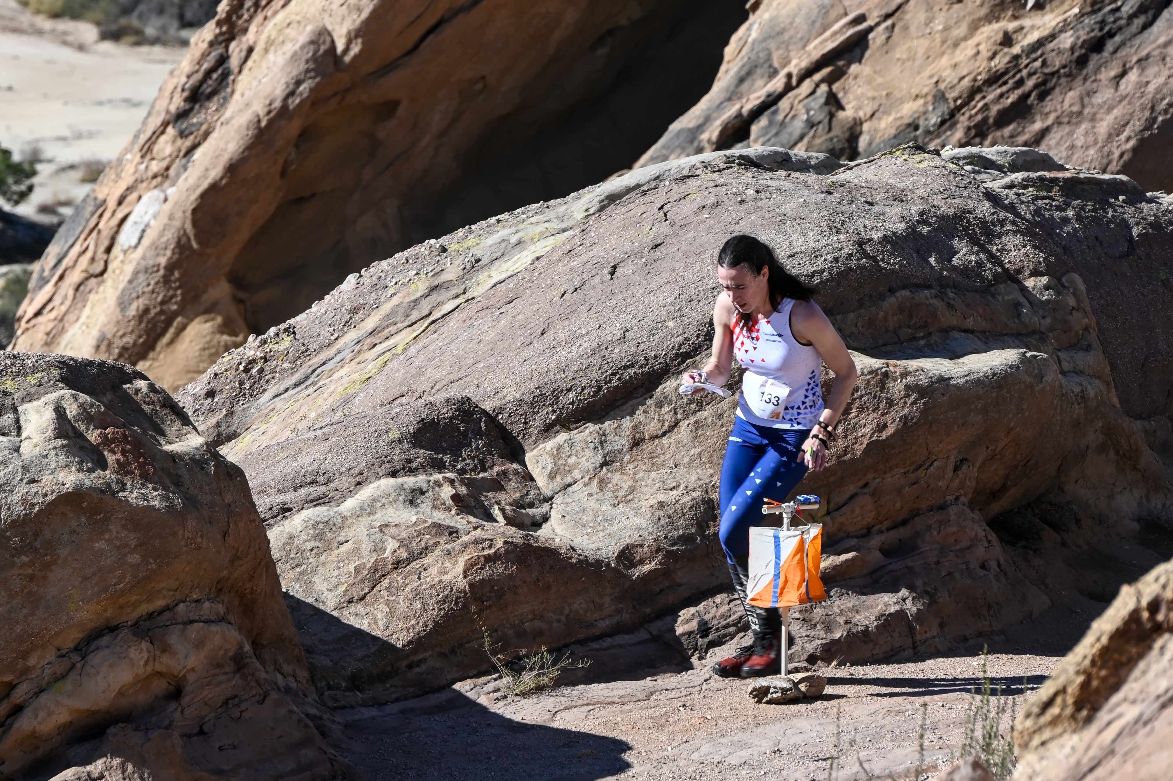 TeamUSA Elite Squad member Alison Crocker (OR) slows briefly to interpret the complex rock detail of Vasquez Rocks Natural Area (Agua Dulce, CA). Alison would go on to win this Women's Elite course to be crowned US Middle Distance Champion for 2022. (Orienteering USA)