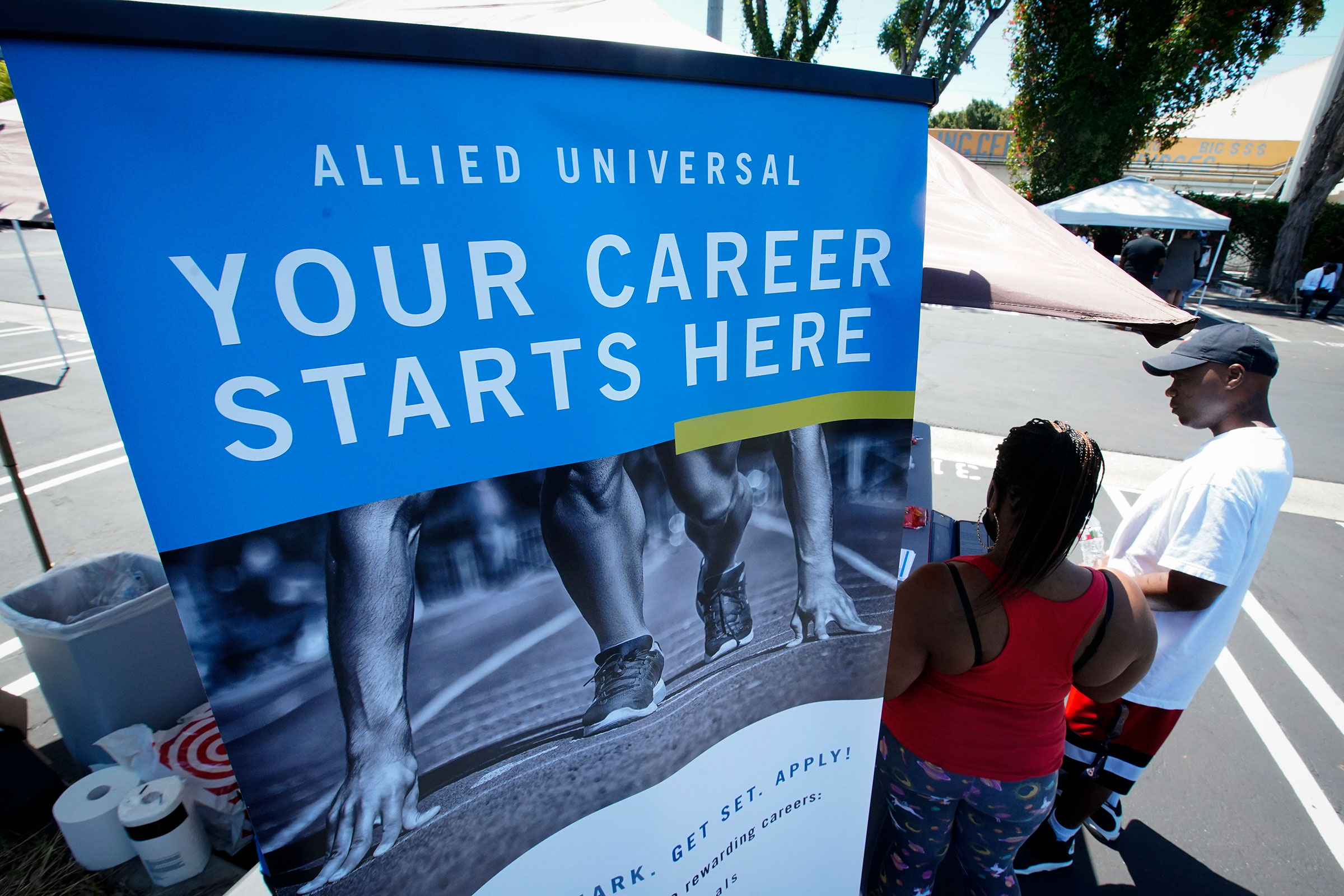 Job seekers fill out an application at a drive up job fair for Allied Universal in in Gardena, Calif. on May 6, 2020.