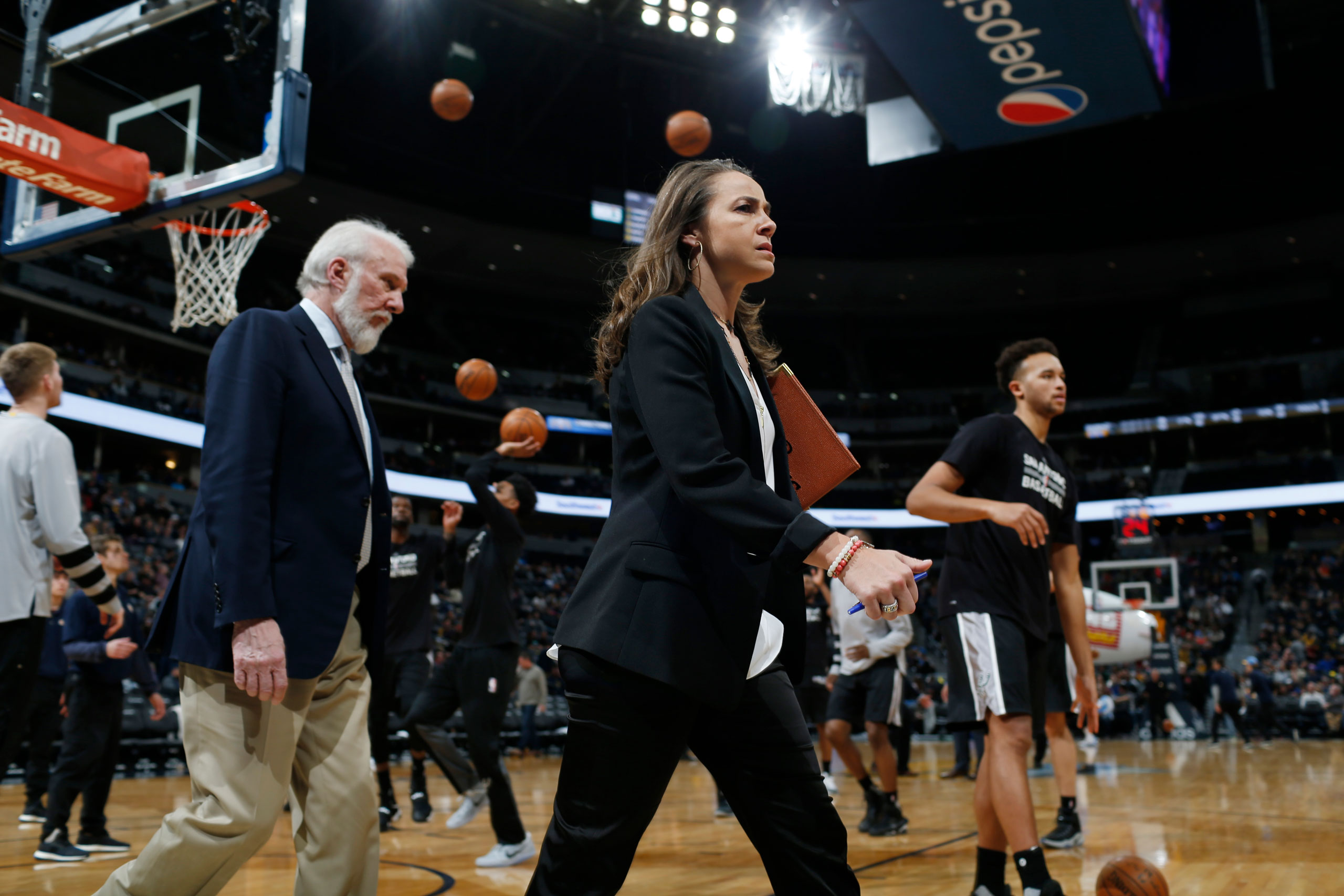 Assistant coach Becky Hammon and head coach Gregg Popovich on the court during a San Antonio Spurs game in 2017. (David Zalubowski—AP)