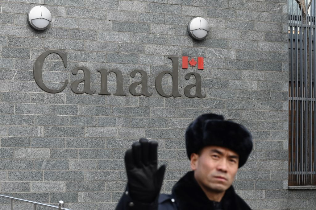 A guard attempts to block photos from being taken outside the Canadian embassy in Beijing, Jan. 27, 2019. (Greg Baker—AFP/Getty Images)
