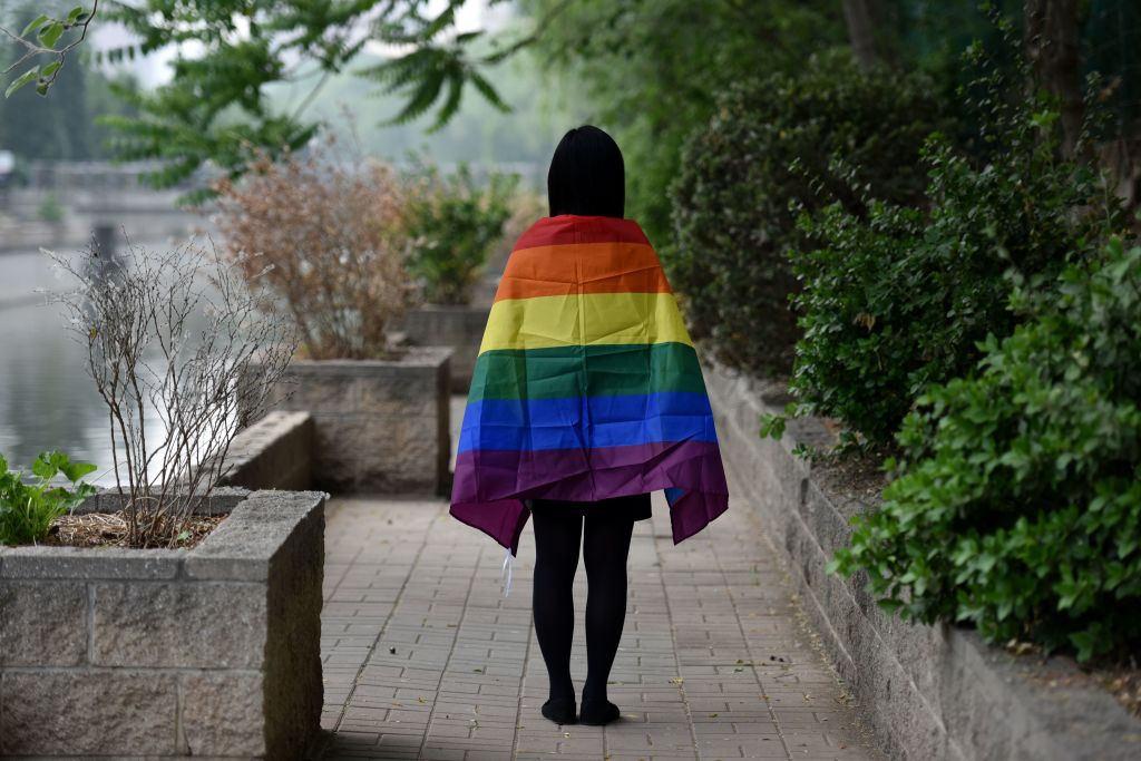 A gay student poses with a rainbow flag in Beijing on May 10, 2019. (Greg Baker–AFP/Getty Images)