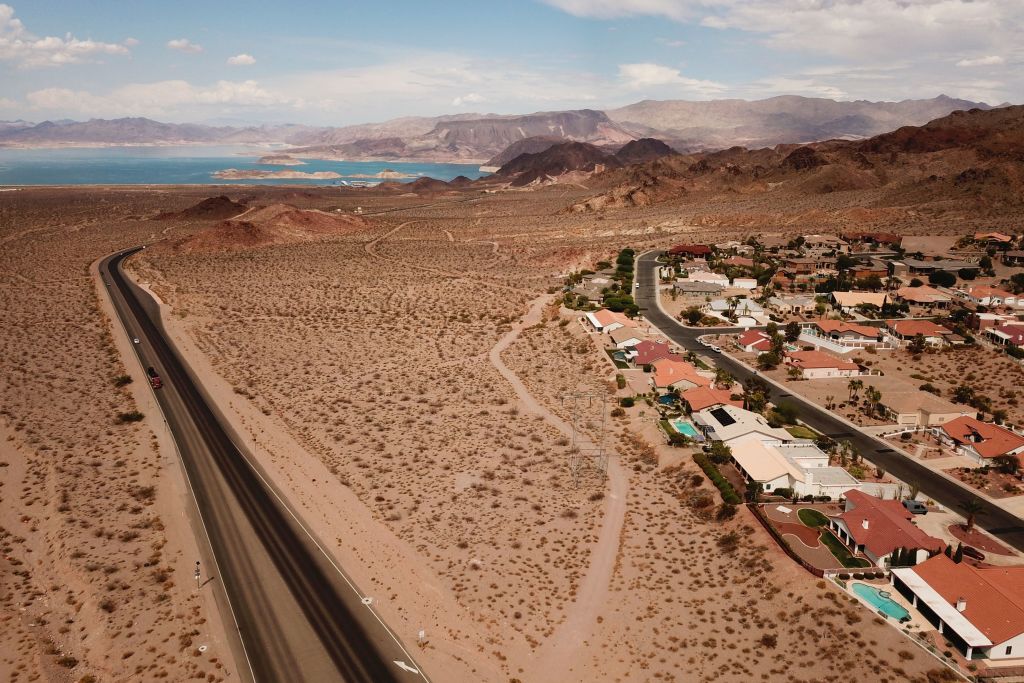 An aerial image shows homes in Bolder City, right, and Lake Mead on the Colorado River, left,  during low water levels due to the western drought on July 20, 2021 from Boulder City, Nevada. (PATRICK T. FALLON/AFP—Getty Images)