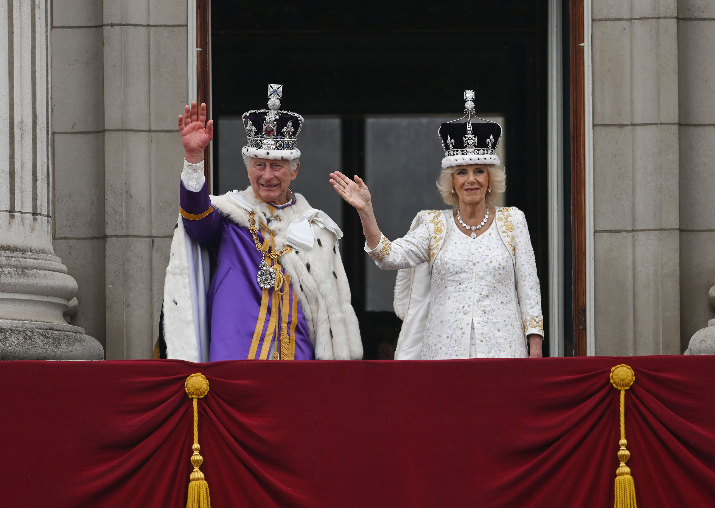 Kral Charles III ve Kraliçe Camilla, Buckingham Sarayı'nın balkonundan el sallıyor.  (Brandon Bell—Getty Images)