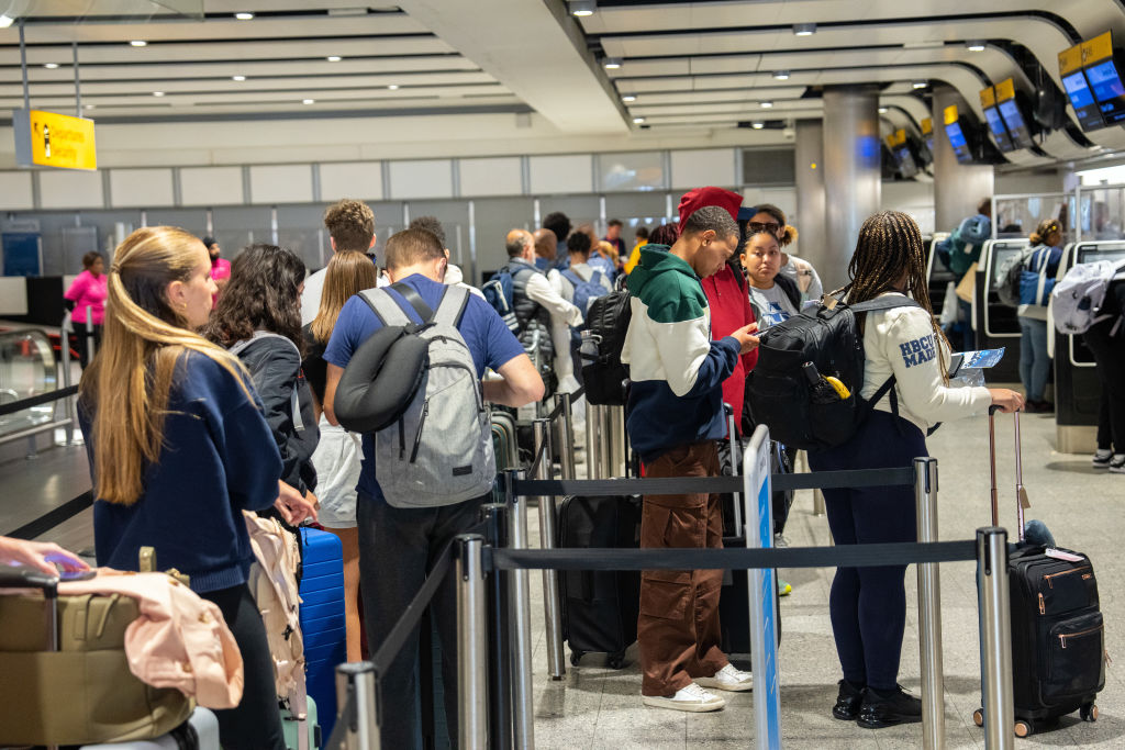 People queue to check in at Heathrow Airport on May 26, 2023 in London, England. (Carl Court—Getty Images)